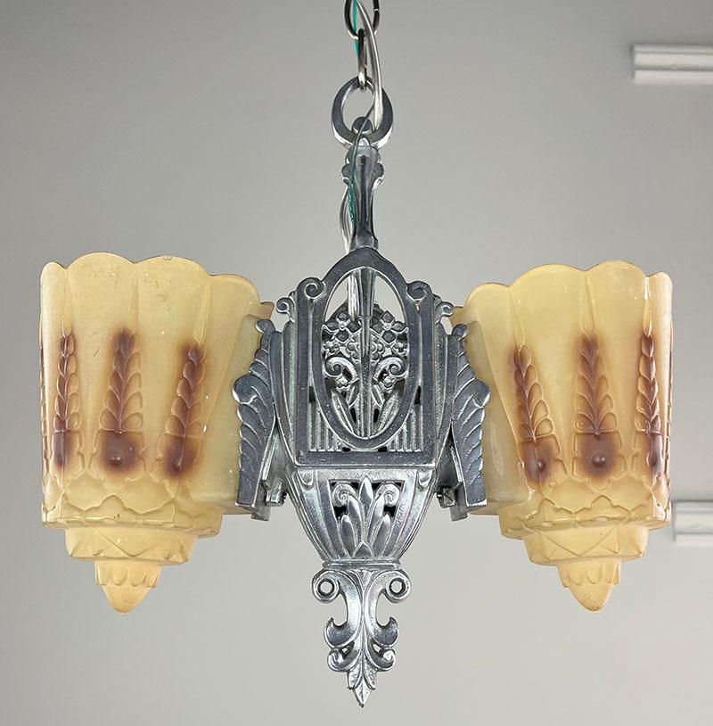 Love these reversible slip shade fixtures. You can either have the shades pointing up for general light or down for directional light. This was made by the Lincoln Manufacturing Co which was located in Buffalo and Detroit. Great fixture where you
