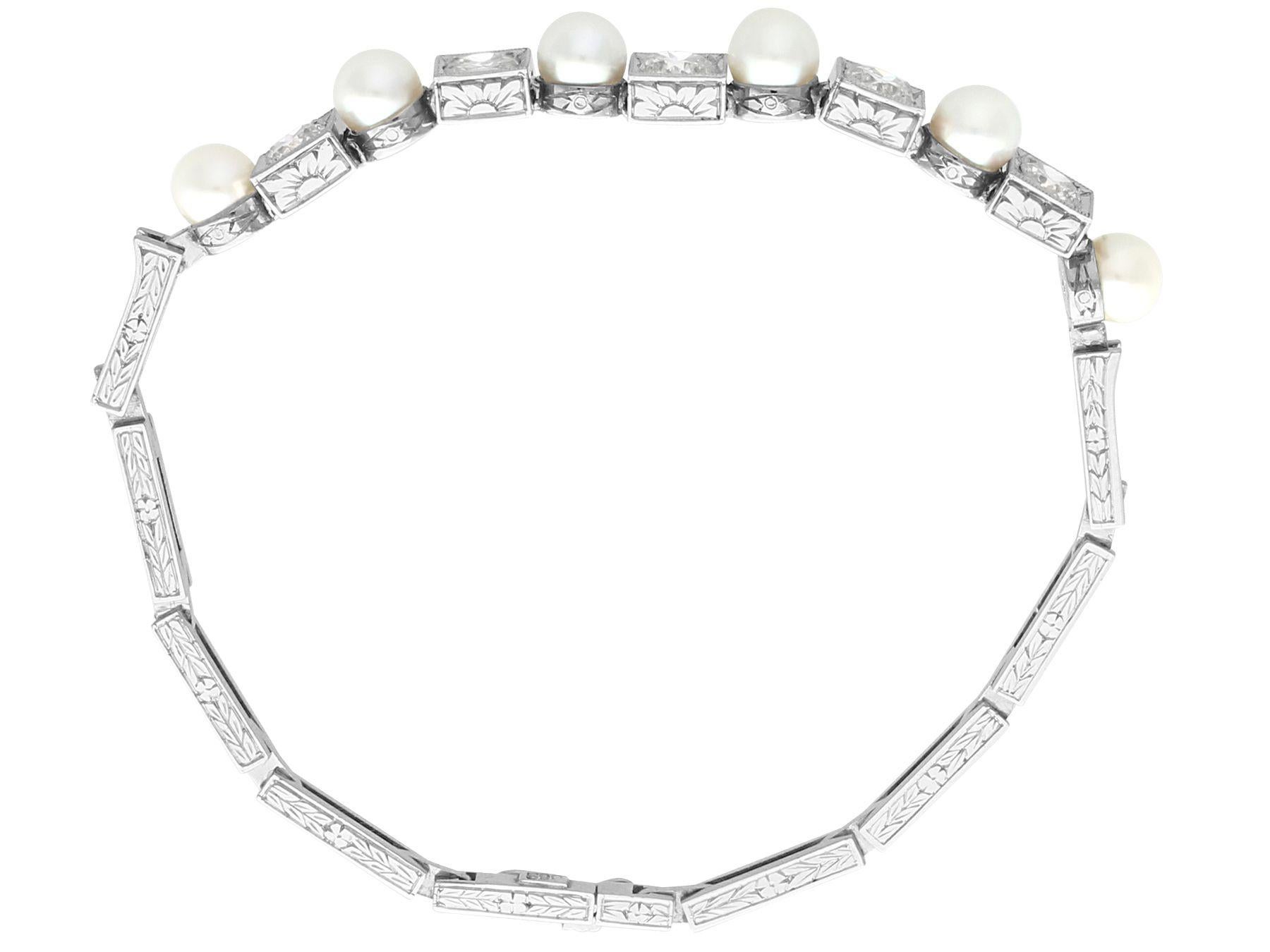 A stunning, fine and impressive antique cultured pearl and 1.38 karat diamond, 15 karat white gold bracelet; part of our diverse antique jewelry and estate jewelry collections.

This stunning, fine and impressive antique pearl bracelet has been