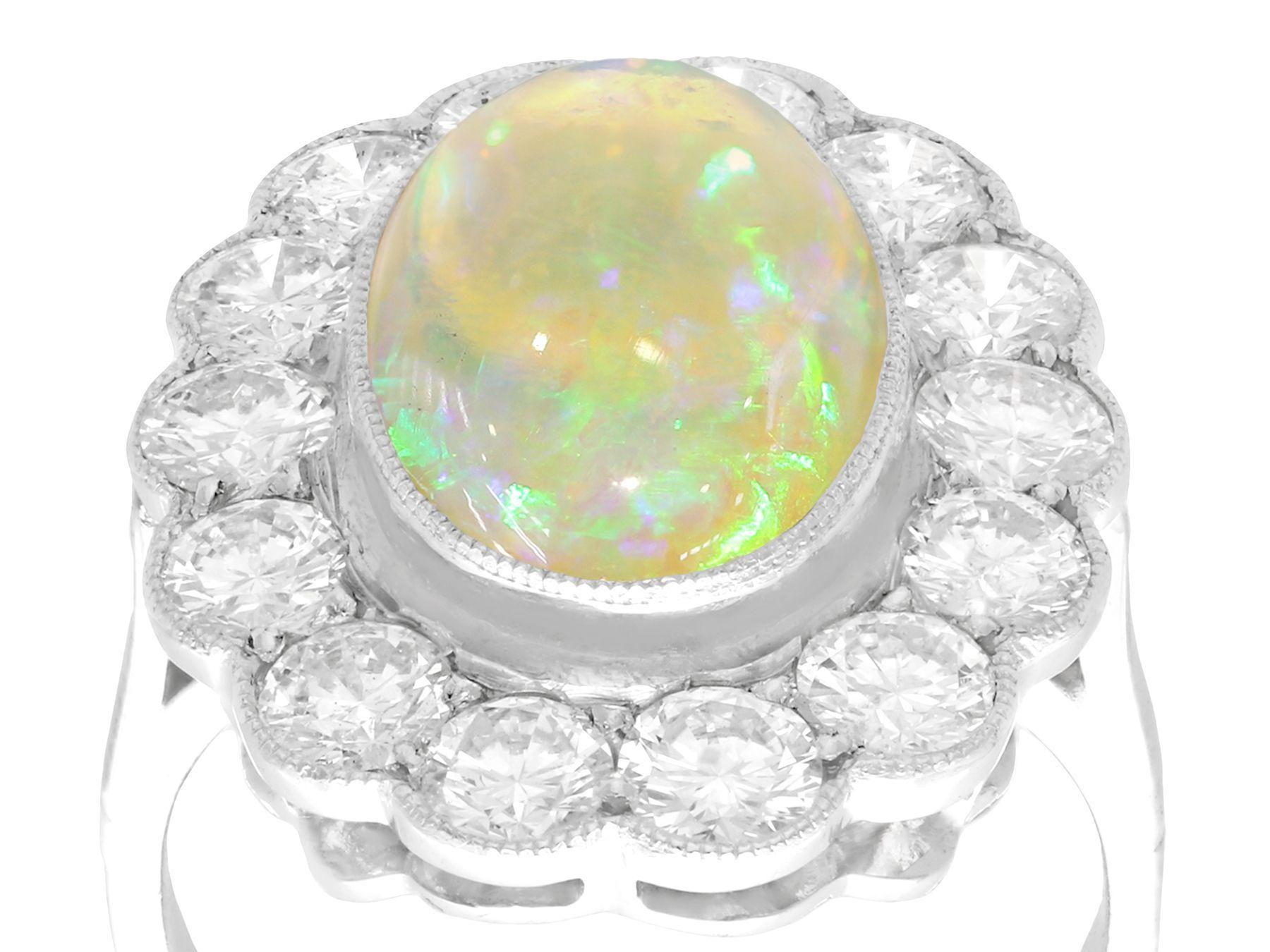 A stunning antique 2.19 carat white opal and 2.36 carat diamond, platinum cluster style dress ring; part of our diverse antique jewelry and estate jewelry collections.

This stunning, fine and impressive antique cabochon cut opal and diamond cluster