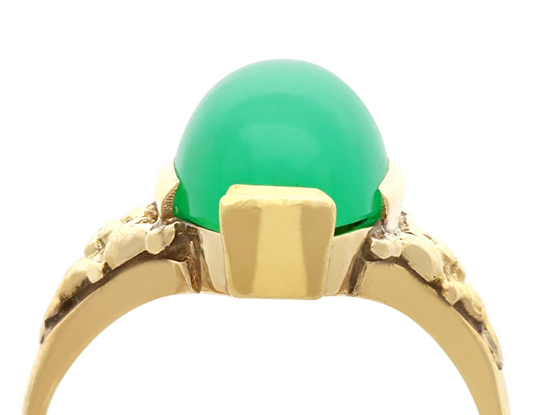 An impressive antique 1930s 6.60 carat chrysoprase and 14 karat yellow gold cocktail ring; part of our diverse antique jewelry and estate jewelry collections.

This fine and impressive antique cabochon cut gemstone ring has been crafted in 14k