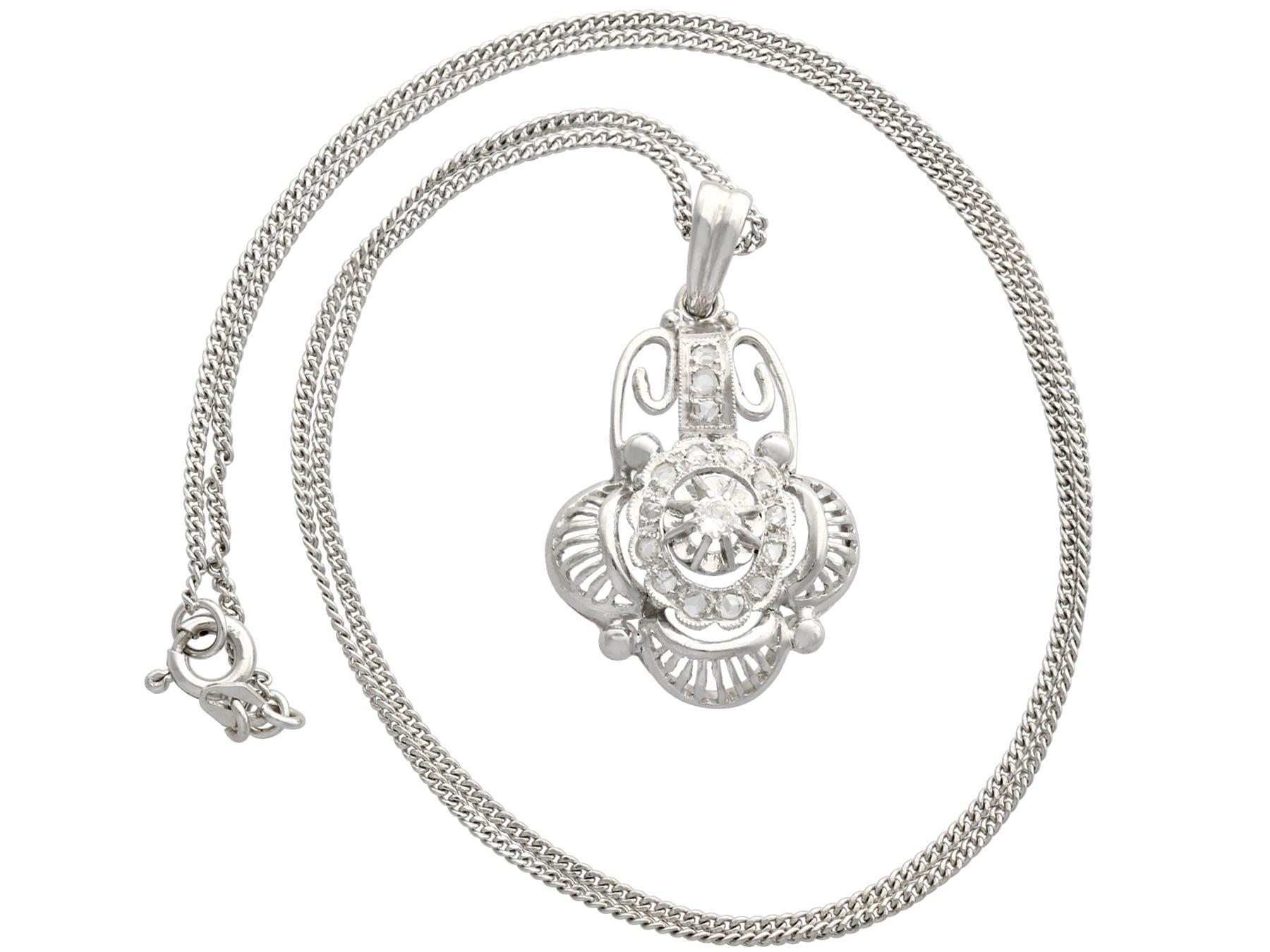 A fine and impressive antique Belgian 0.20 carat diamond and 18 karat white gold pendant; part of our diverse antique jewelry and estate jewelry collections.

This fine and impressive has been crafted in 18k white gold.

The pierced decorated