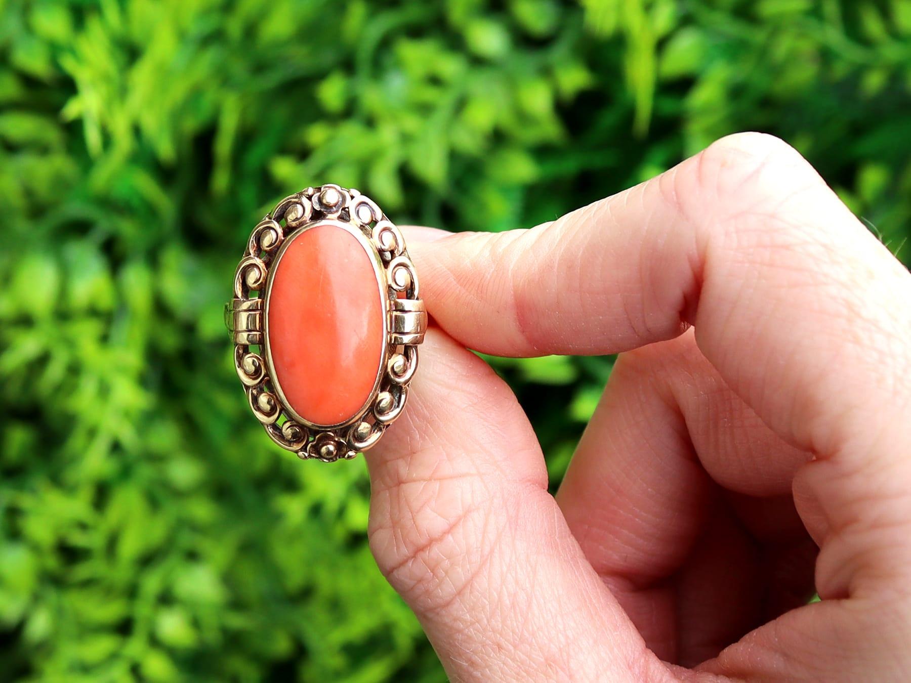 A fine and impressive antique natural coral and 14 karat yellow gold cocktail ring; part of our antique jewelry and estate jewelry collections.

This fine and impressive antique cabochon cut coral ring has been crafted in 14k yellow gold.

The