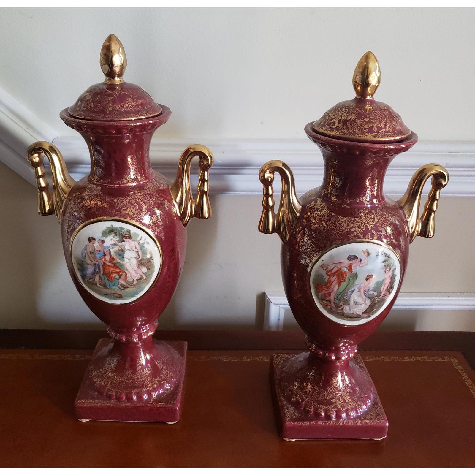 Antique Empire England Urn. This deep sienna piece feature 24 carat gold plated handles and fine floral patterns across all surfaces. These 1930s hand made urns set has been carefully kept and is still in great condition. The scene is of 4 women.