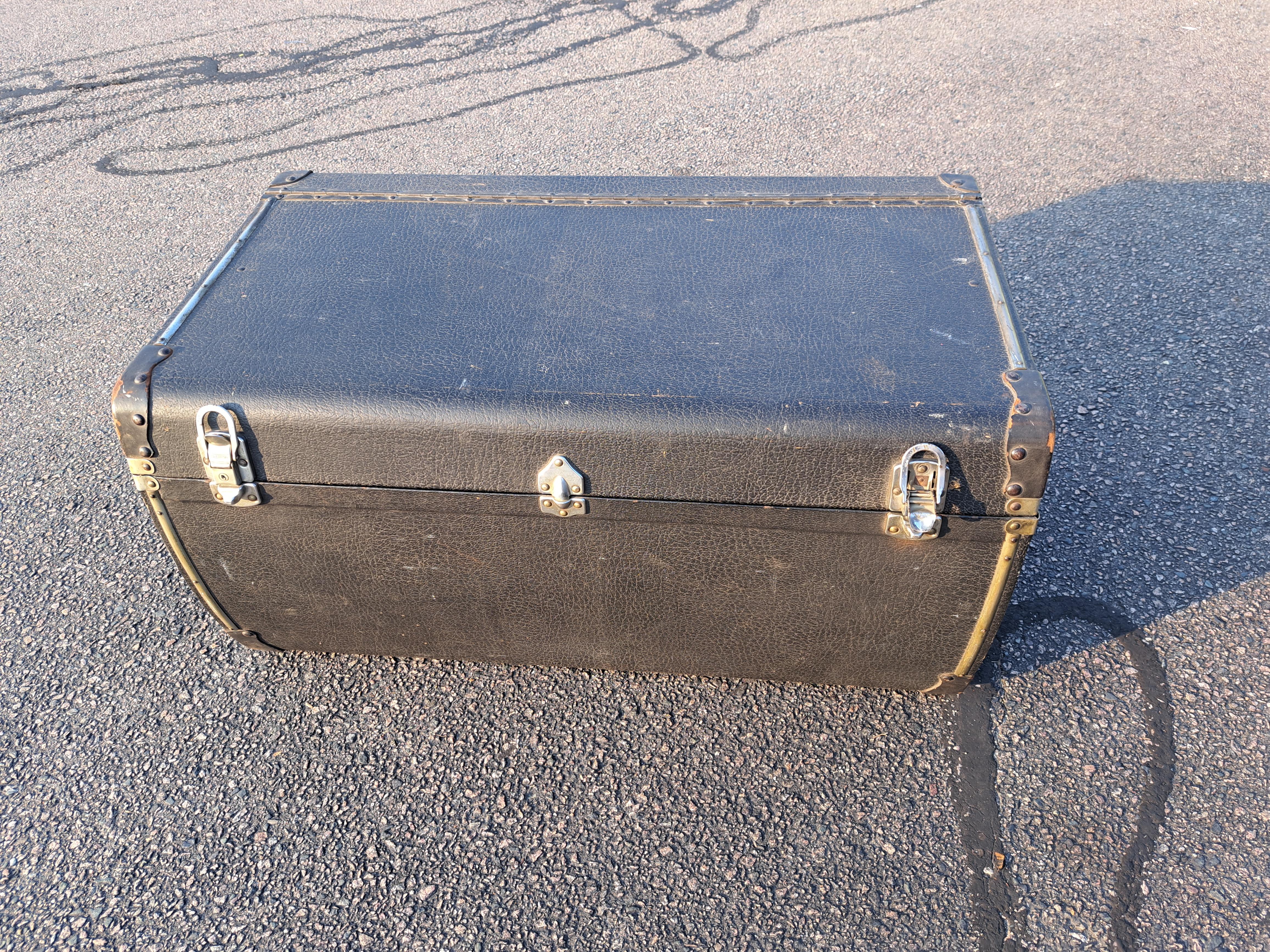 Antique 1930's exterior auto trunk made of leather with chrome fittings. Trunk is in good clean condition with flat top and curved front.
