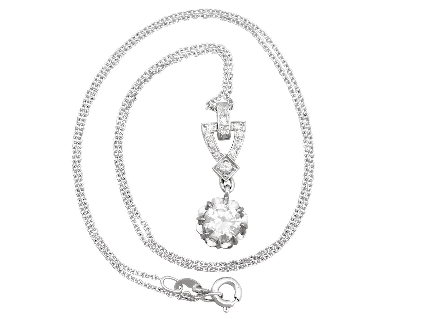 A stunning antique French 0.96 carat diamond and platinum pendant with an 18 karat white gold chain; part of our diverse antique jewelry collections.

This stunning, fine and impressive antique diamond drop pendant has been crafted in platinum, with