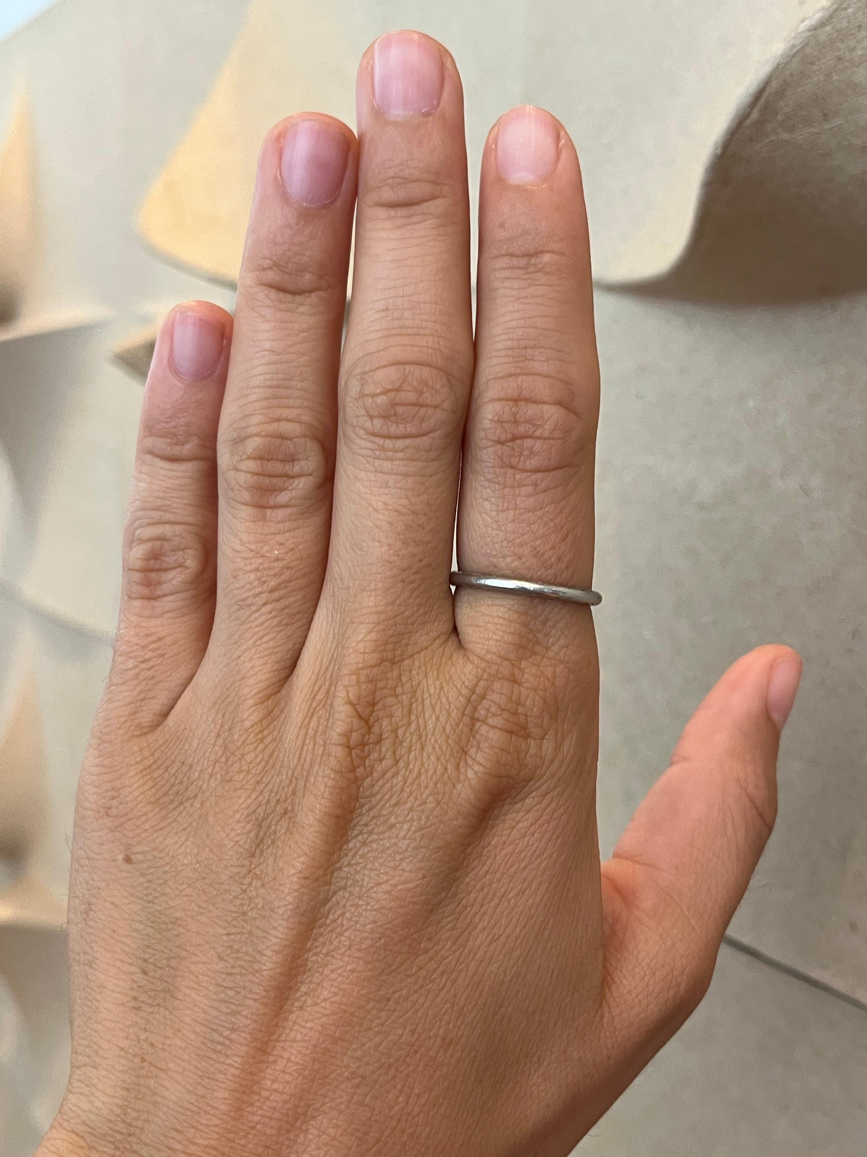 From the Bracken Jewelers antique fine jewelry collection in Santa Monica, California. This antique 1930s platinum wedding band features a hand-engraved geometric design and is perfect for stacking with matching period and modern engagement
