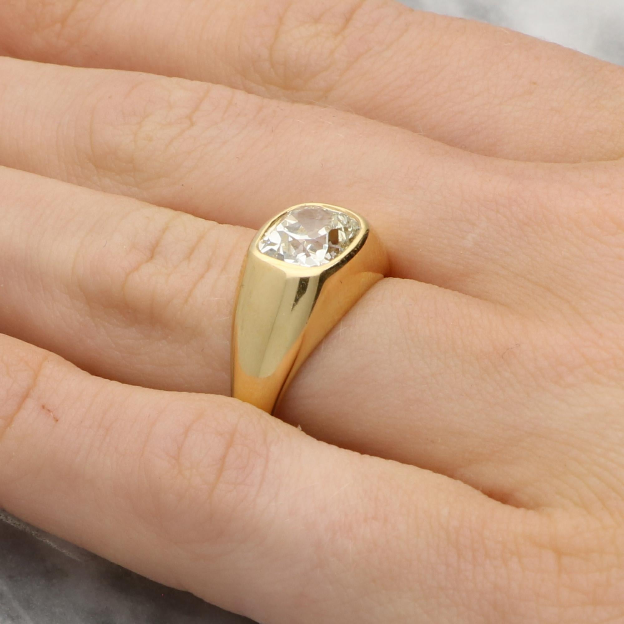 A beautiful antique 1.93ct old cushion cut East-West diamond ring set in 18k yellow gold. 

The piece is centrally set with a sparkly 1.93ct old cushion cut diamond which is securely bezel set in this hand crafted chunky gold mount. The cushion is