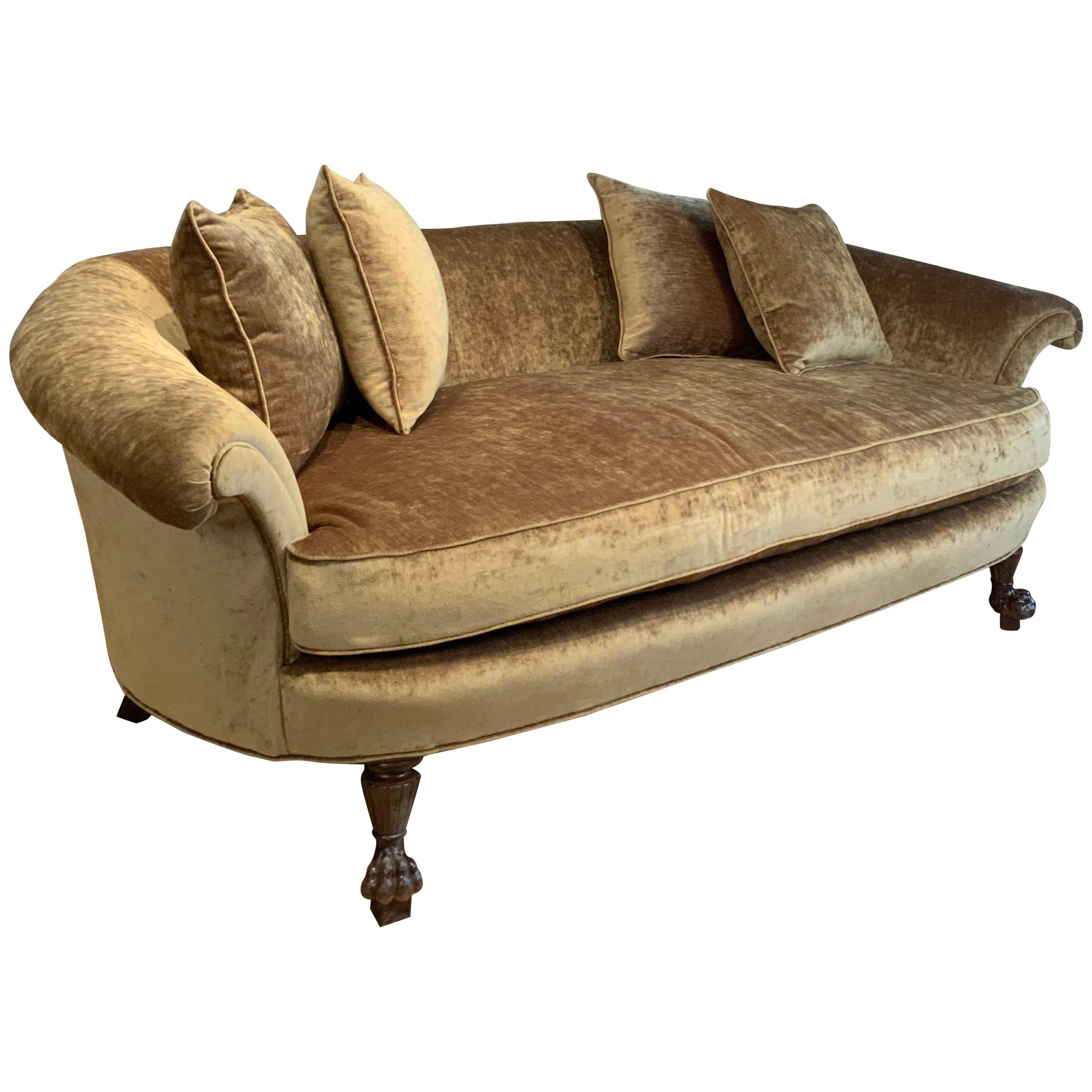 A beautiful and very comfortable antique 1940s sofa with a large gracious curved back, and loose pillows. Wonderful scale and proportions, this sofa was just freshly reupholstered in a beautiful beige/gold velvet. Luxurious fabric and great subtle
