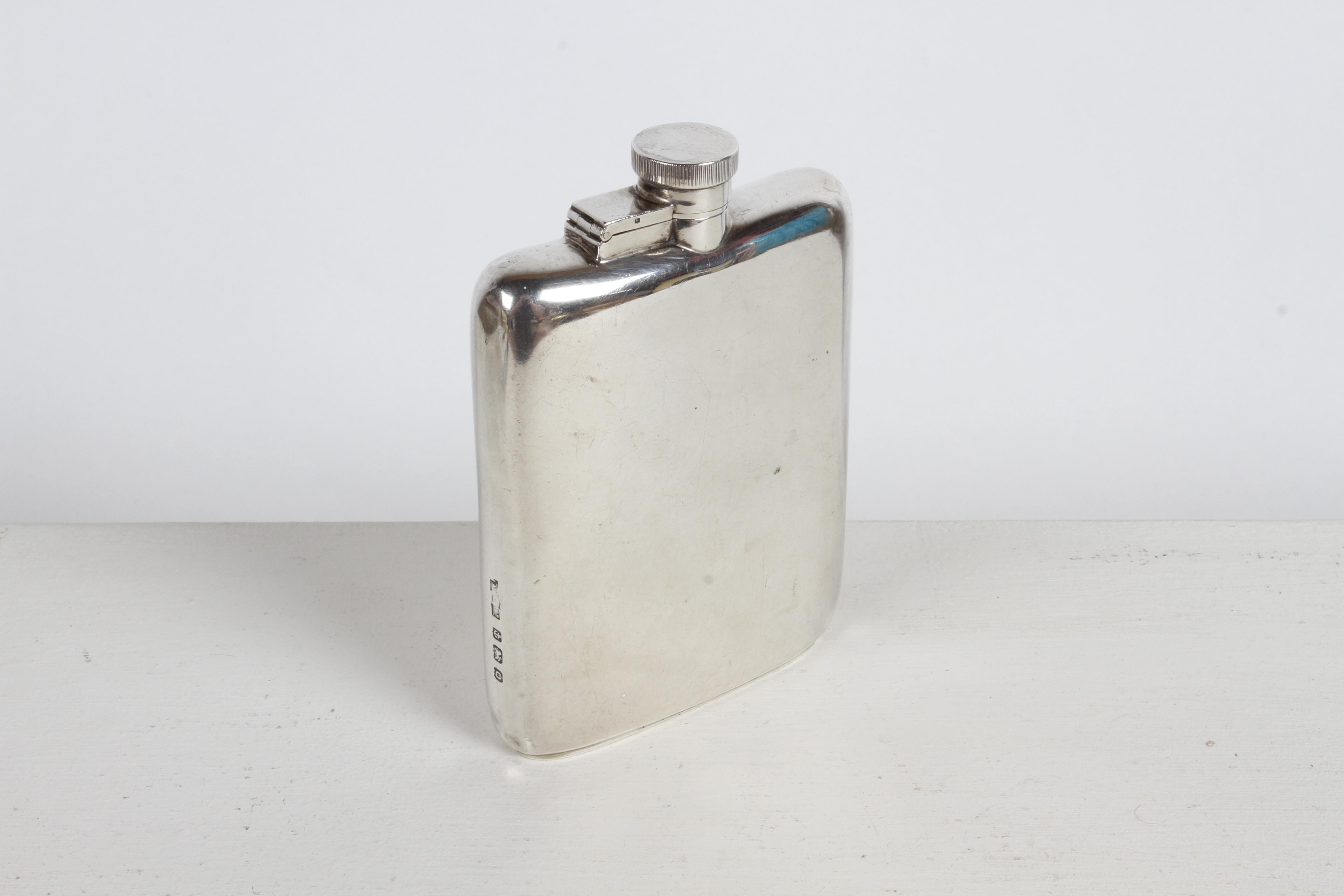 Sleek & elegant gentleman's pocket spirits hip flask in sterling silver by Asprey London circa 1940 with slight curve to body, great craftsmanship. Hallmarked Asprey London with assay marks of a Lion & Q. Has typical scuffs and a few dings from use
