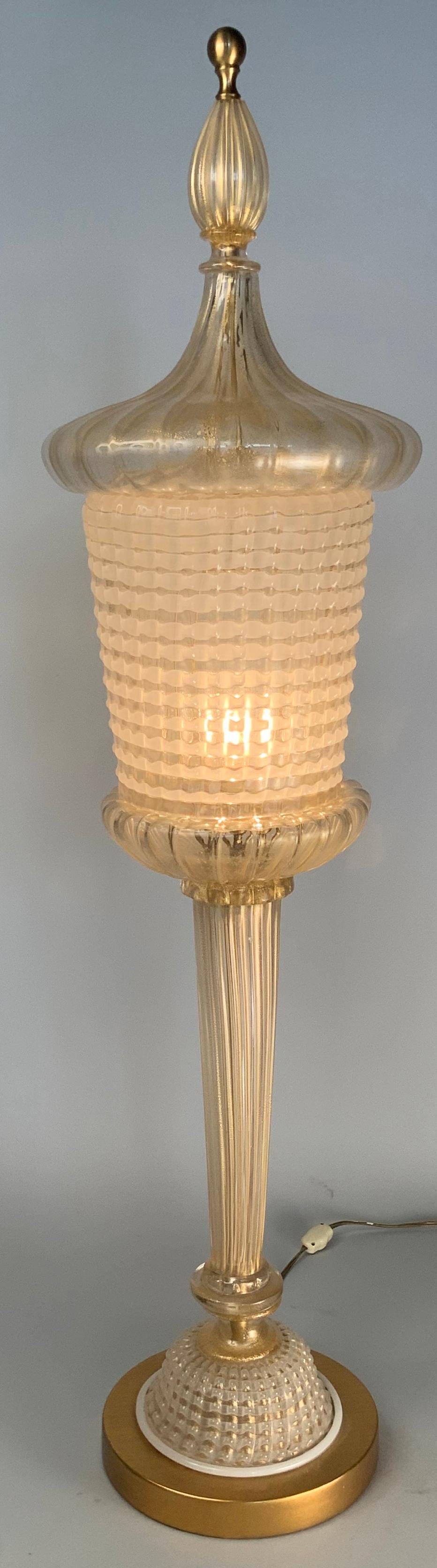 A stunning and rare antique 1940s table lamp in a torch or lantern form entirely of Italian Murano glass designed by Barovier. Beautiful glass with gold leaf and bubbles swirled into the glass. Mounted on a gold leafed wood base.