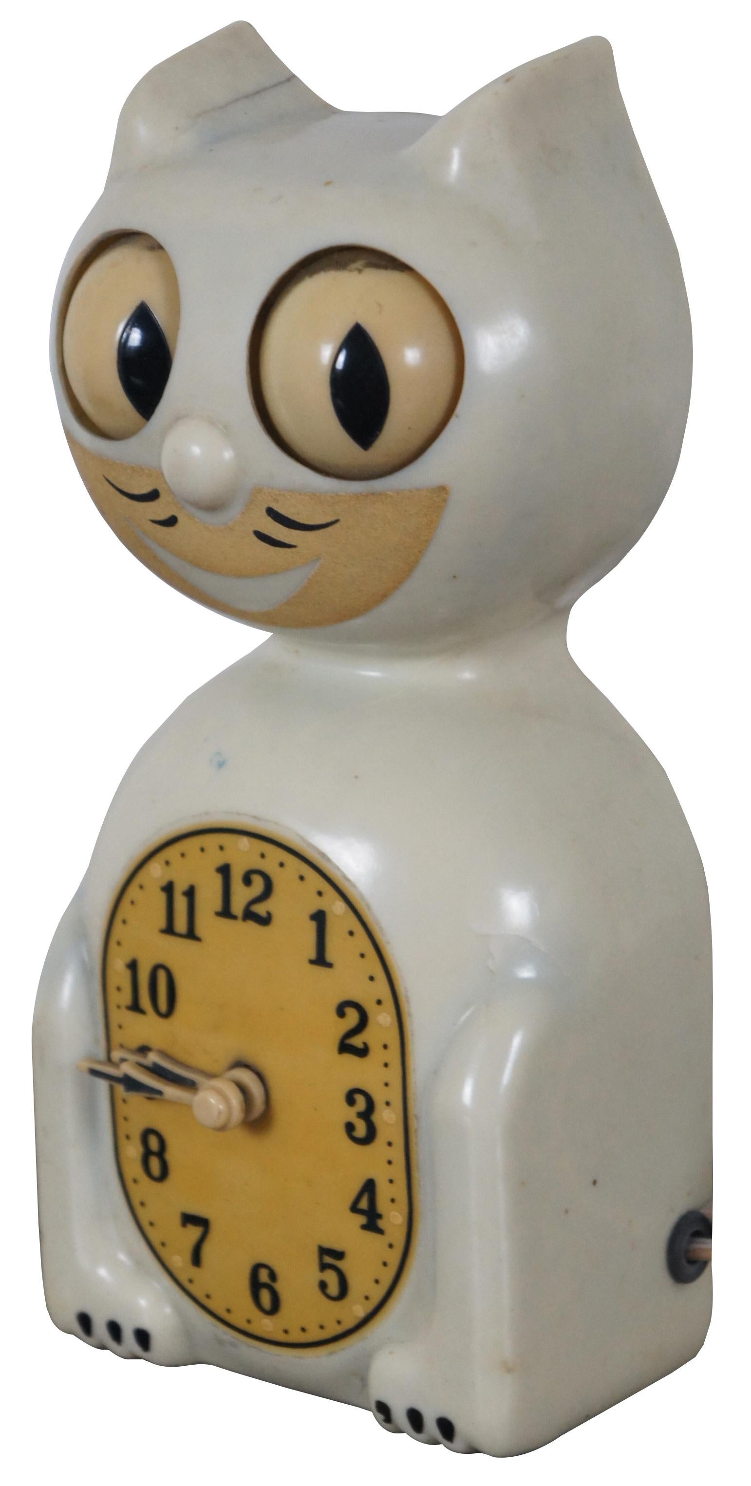 Antique 1940s ivory and yellow kit cat klock by the Allied Manufacturing Co, Model C2.
 