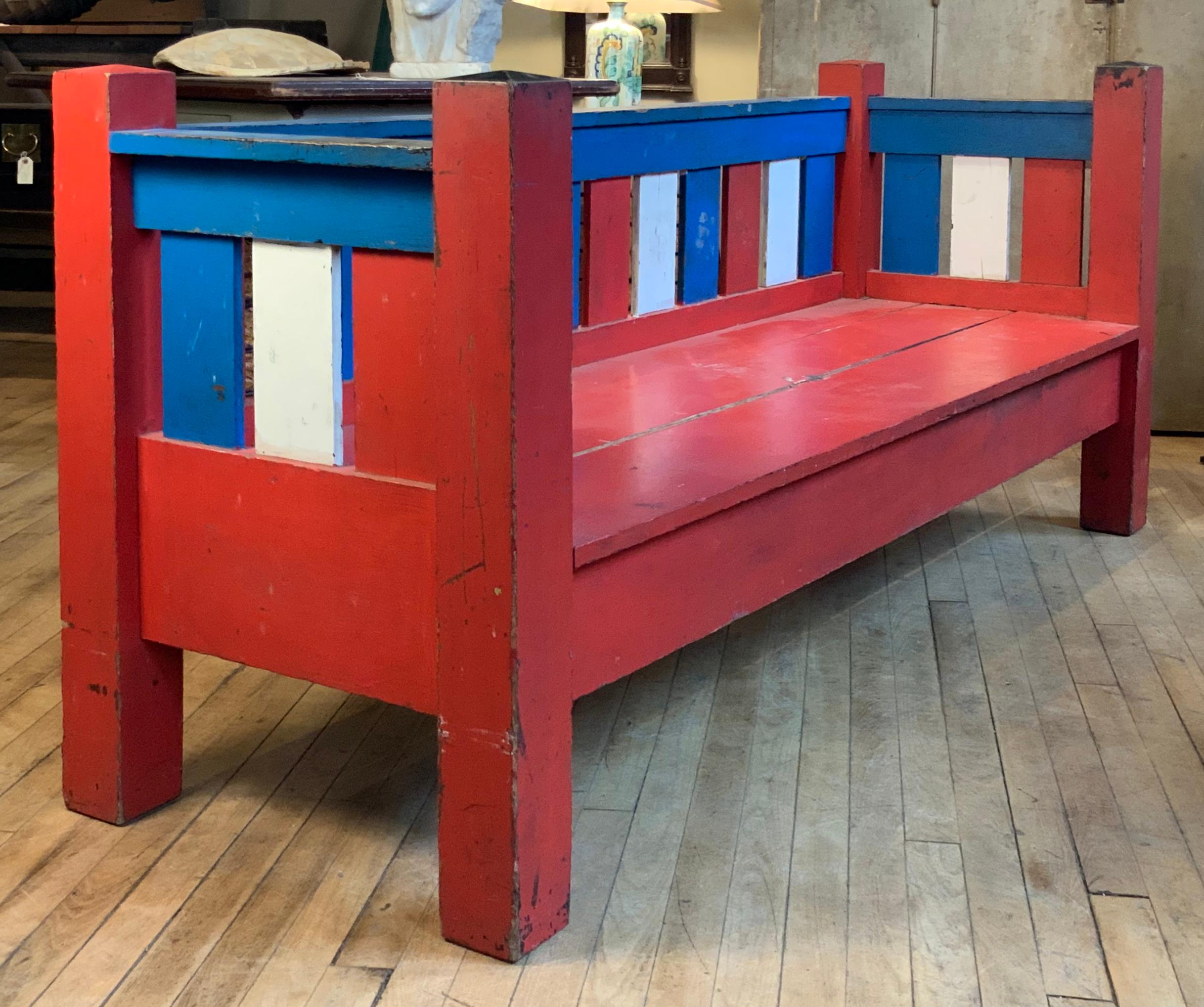 An unusual and unique antique 1940s Arts & Crafts settee in Folk Art patriotic painted finish in red white and blue -- wonderful and engaging treatment of this very stable bench settee.