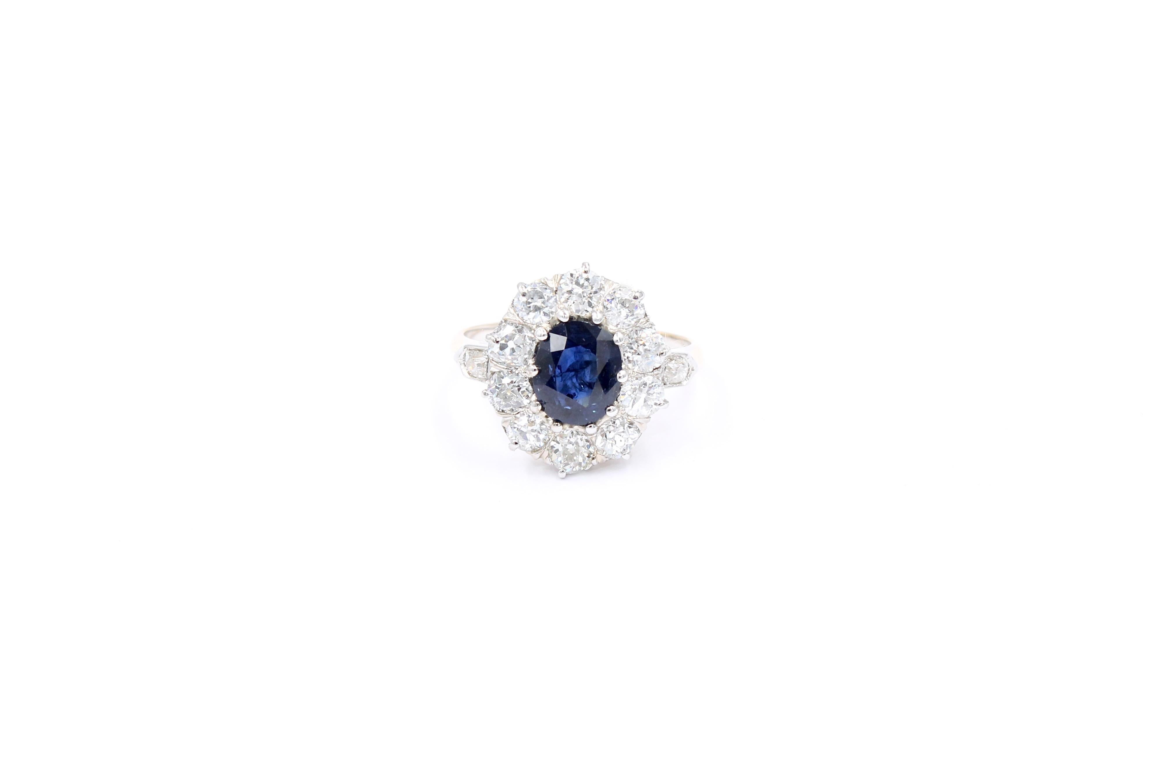 Antique cluster ring circa 1900. 

Ring set with a center deep blue sapphire of 1.97 Carats and 10 old European cut natural diamonds for a total of approximately 1.50 Carats ( estimated G color - Vs/Si clarity). 

Ring made of gold 18 Karat, Yellow