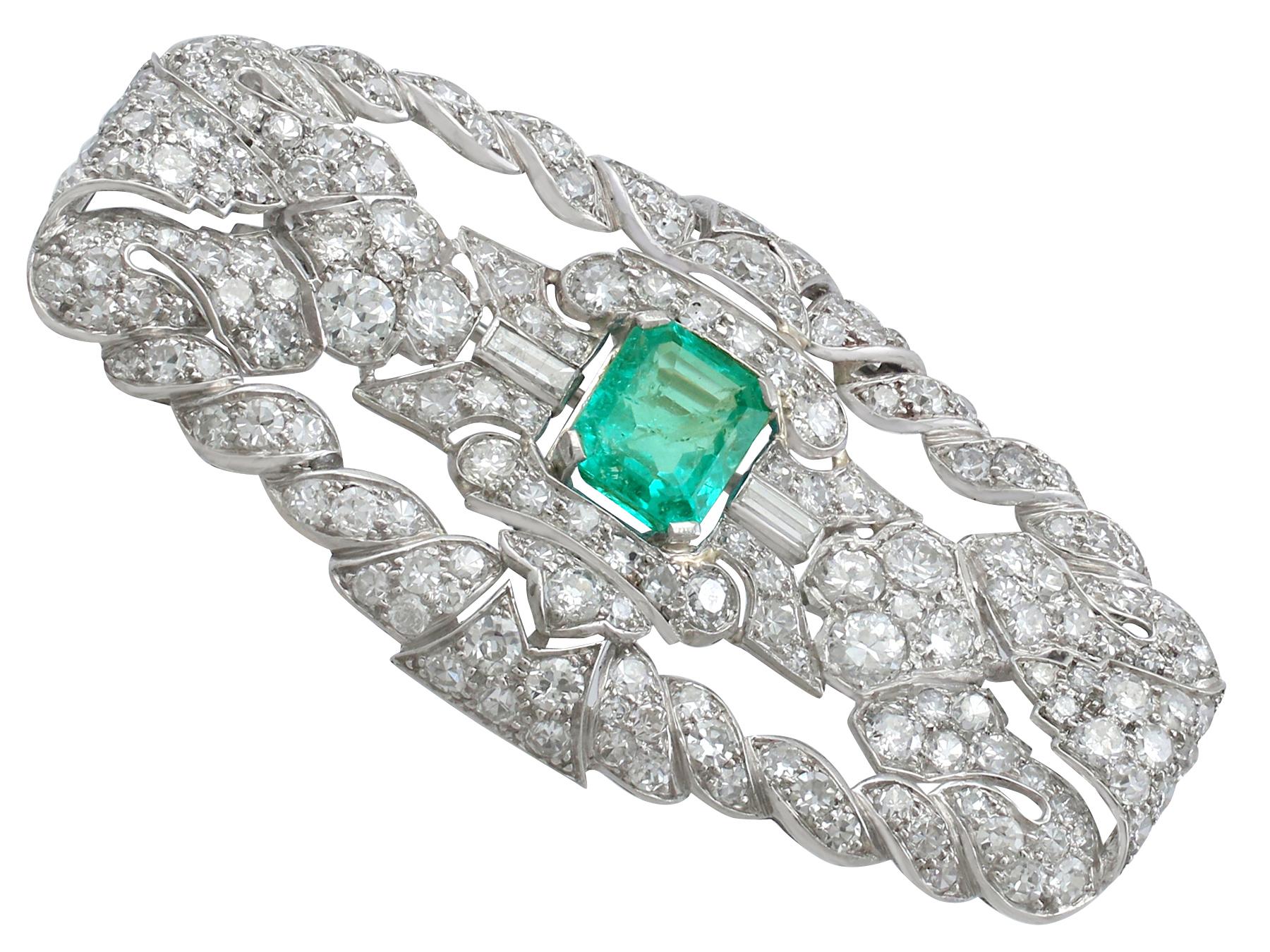 A stunning, fine and impressive 1.98 Ct emerald and 5.22 Ct diamond brooch in platinum; part of our authentic antique Art Deco jewelry/jewelry collection.

This stunning example of antique emerald and diamond brooch has been crafted in