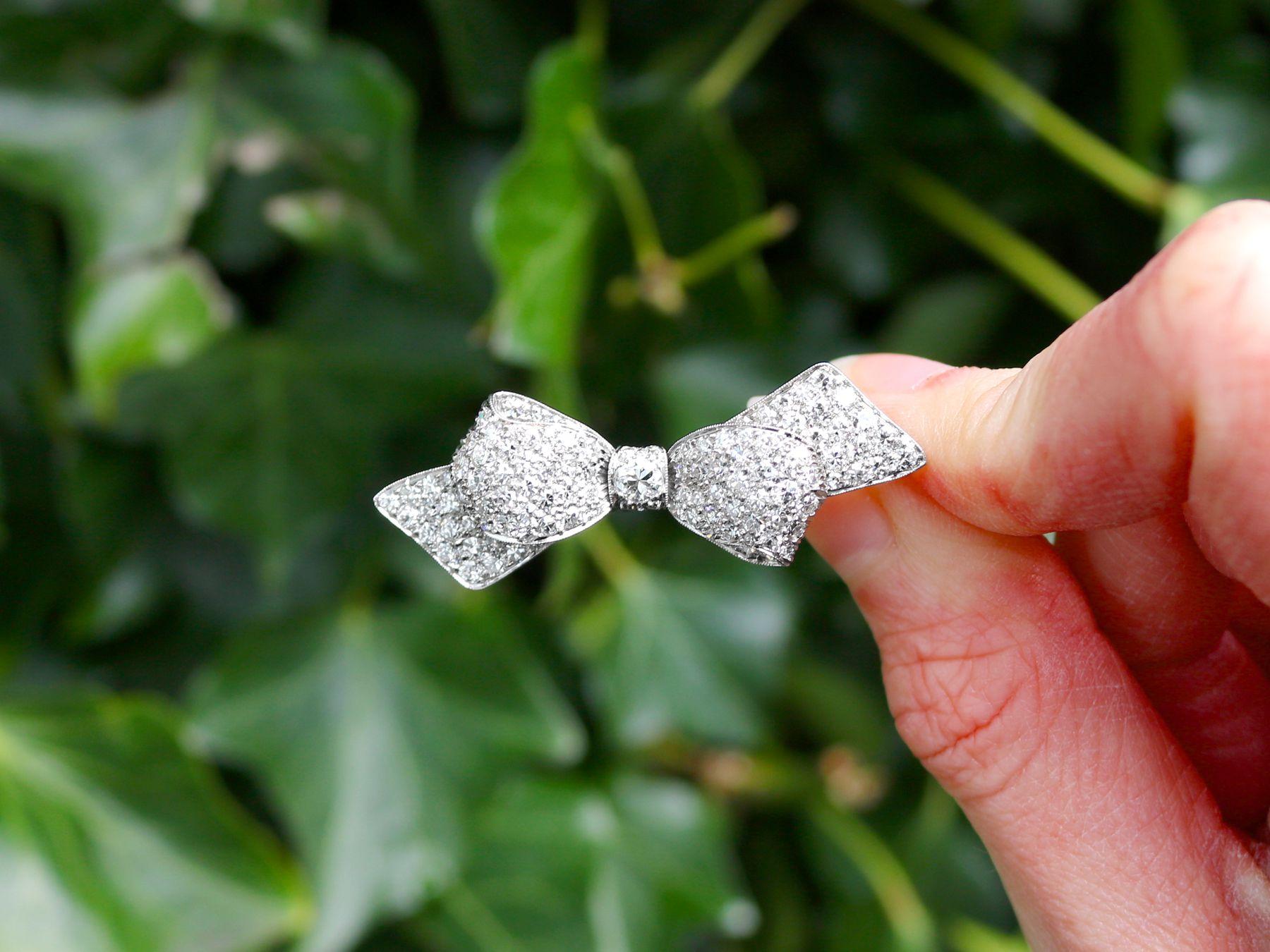 Round Cut Antique 1.99 Carat Diamond and Platinum Bow Brooch Circa 1900 For Sale