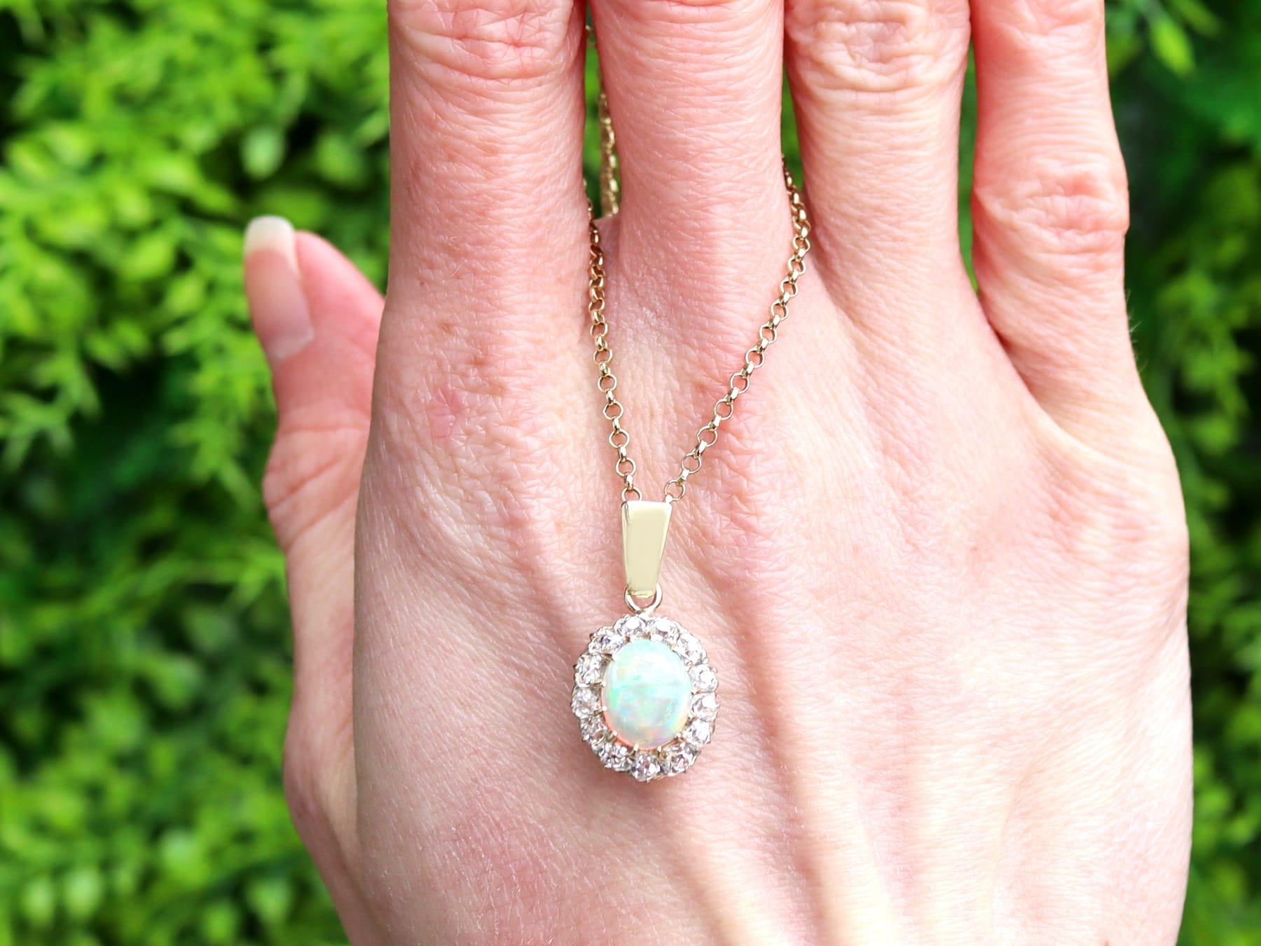 A stunning and impressive antique 1.99 carat white opal and 1.02 carat diamond, 9 karat yellow gold cluster pendant; part of our diverse antique jewellery collections

This stunning, fine and impressive antique opal cluster pendant has been crafted