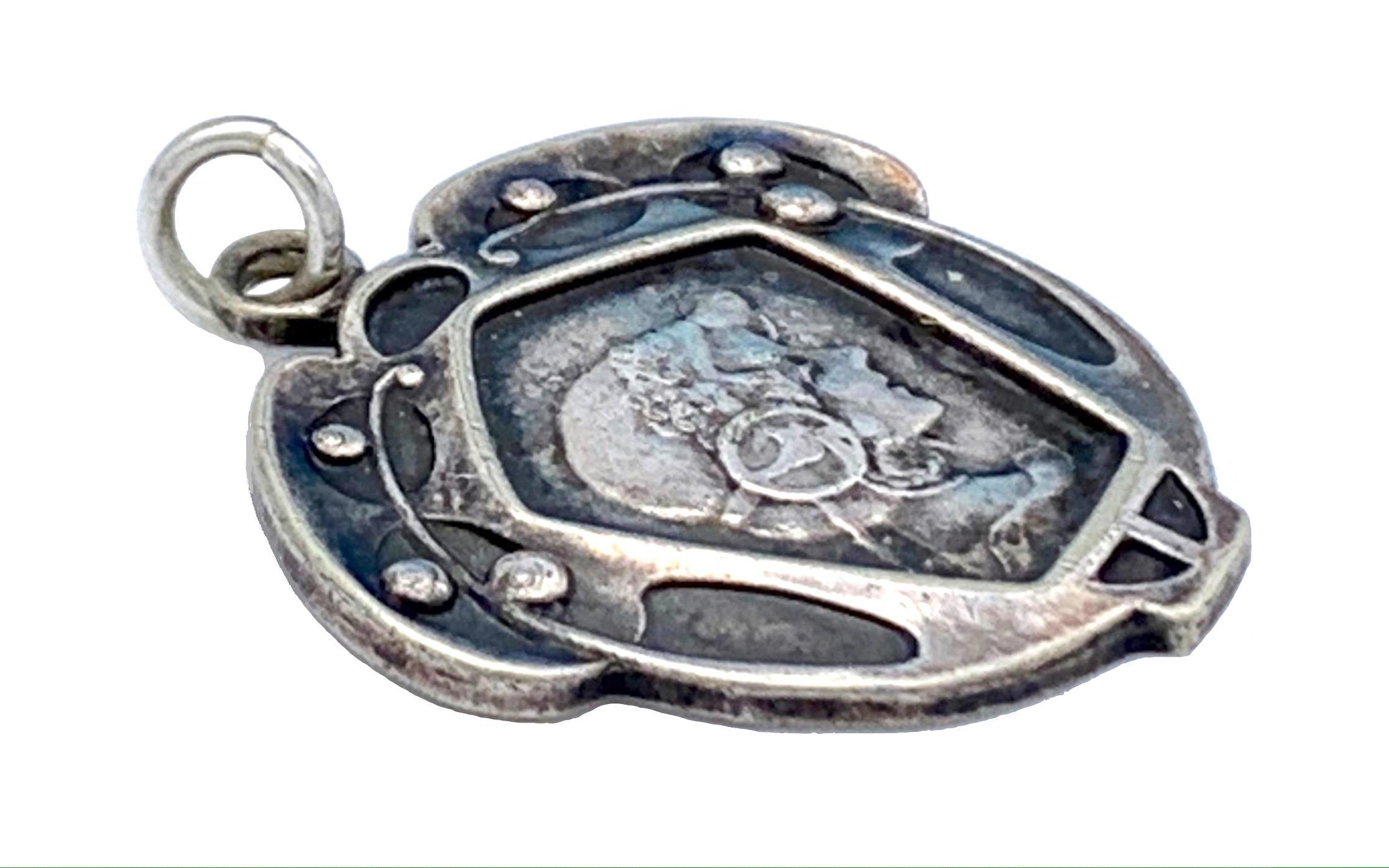 This charming Art Nouveau pendant  of a young lady makes an ideal gift for a young girl girl. 