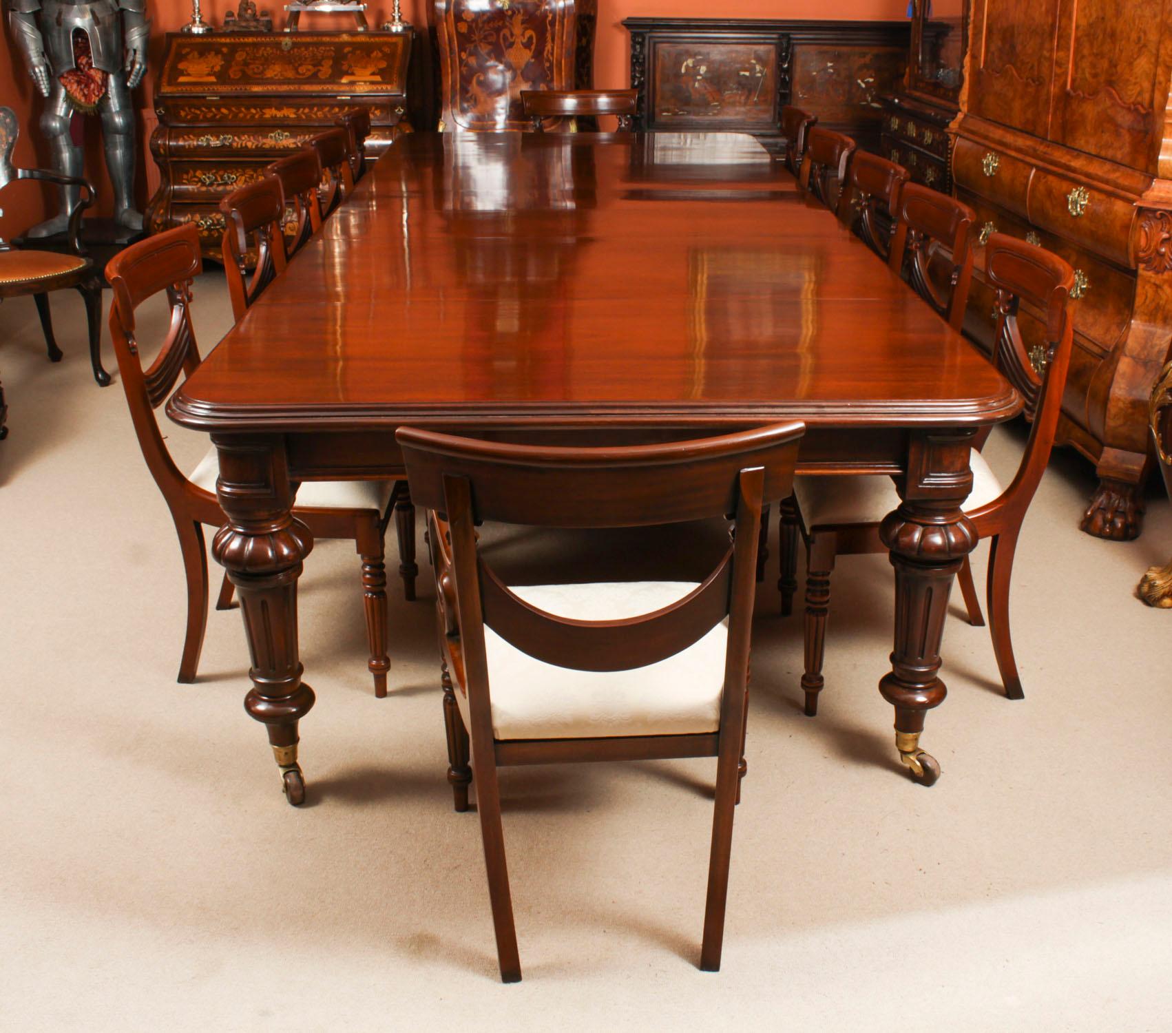 This is a beautiful dining set comprising an antique William IV flame mahogany dining table, Circa 1835 in date, and a beautiful set of fourteen Regency Revival Swag back dining chairs.
 
This amazing table can seat fourteen people in comfort and