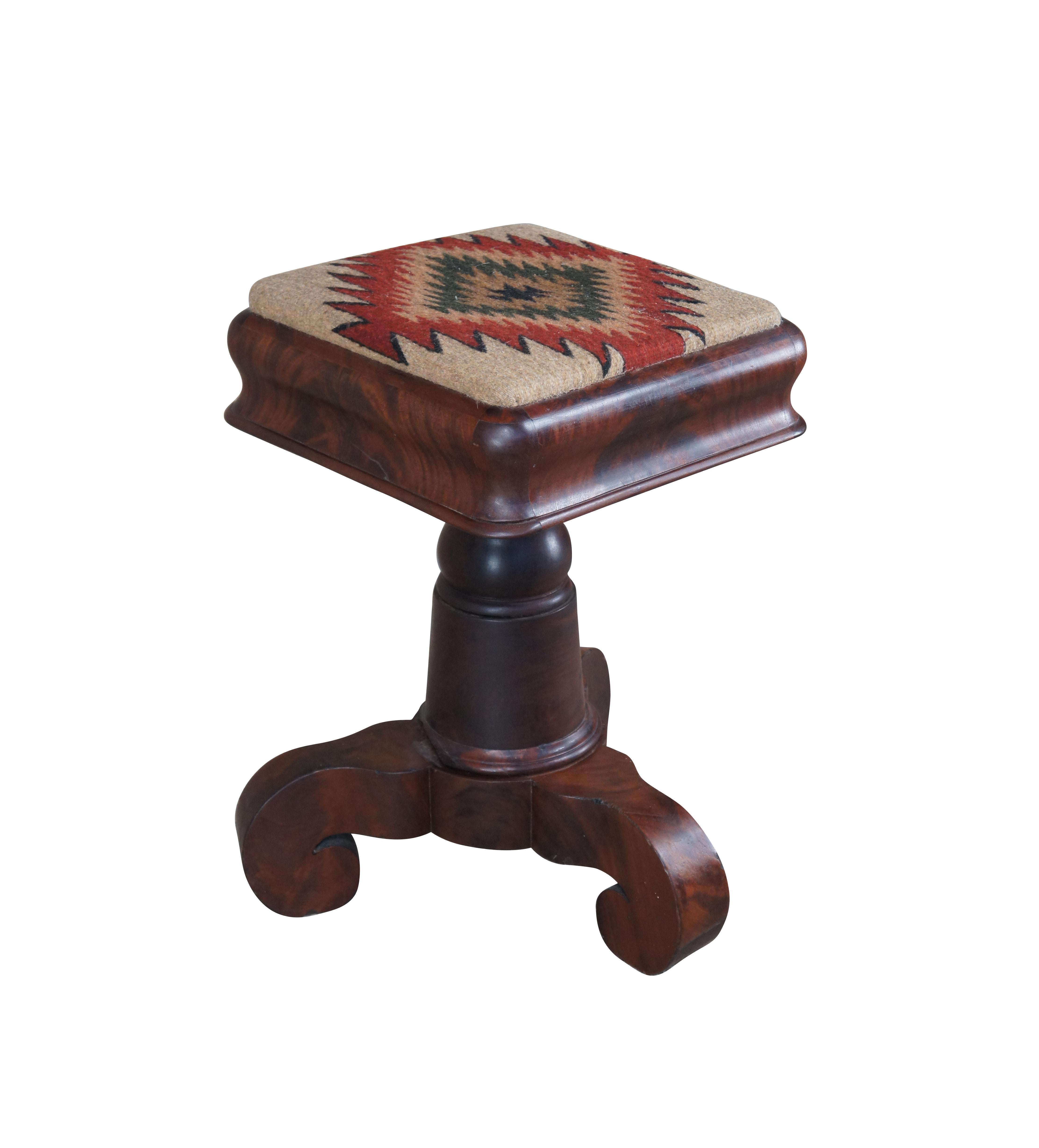 A spectacular Piano or Organ stool from the American Empire period, circa 1840s. Feature a mahogany frame with crotch mahogany (burled) veneer. The square frame seat features a Southwestern Kilim upholstered seat and is supported by a graduated