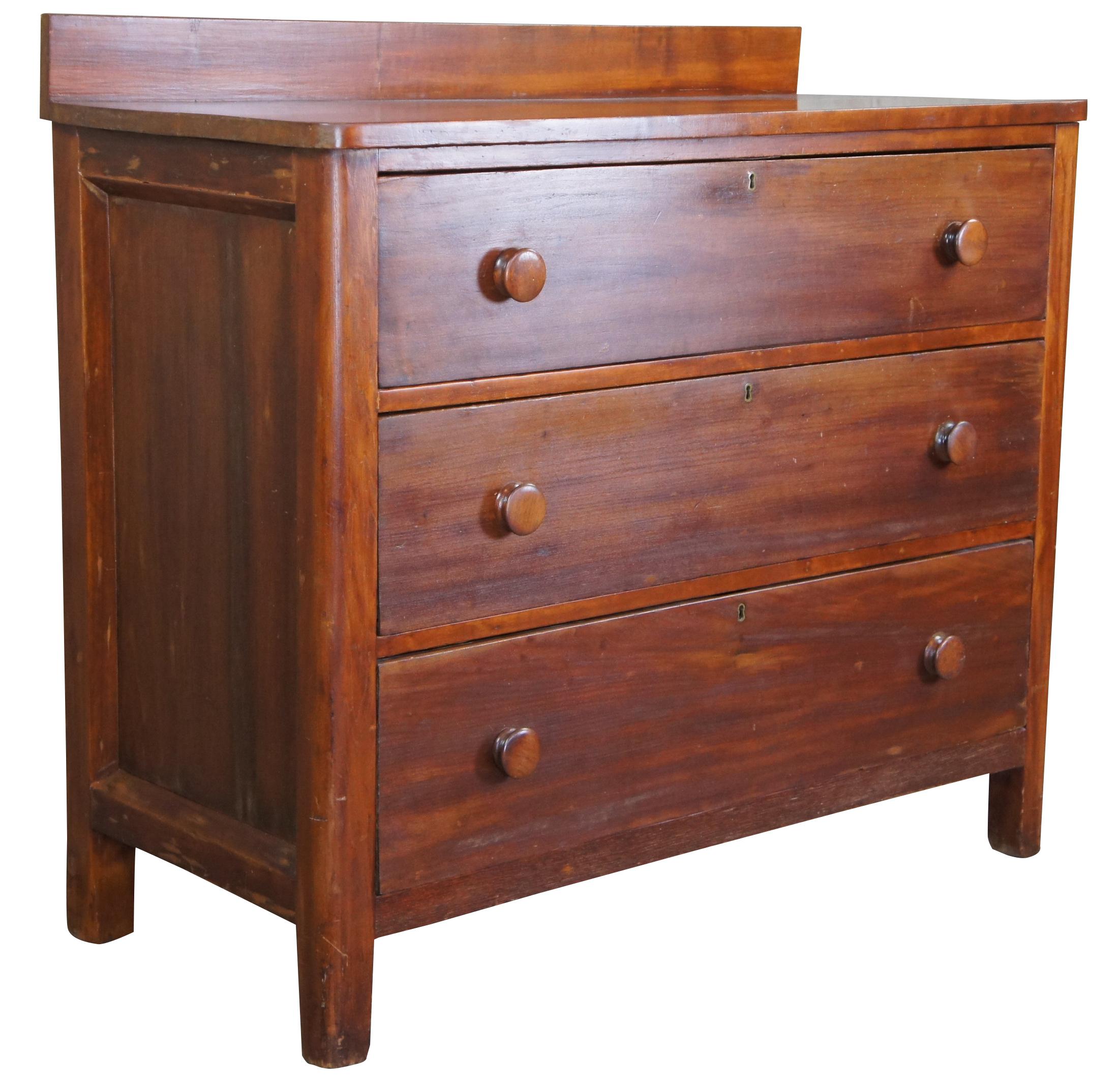 Civil War era chest of drawers. Made of cherry featuring three hand dovetailed drawers with turned knobs, paneled sides, and backsplash.

Measures: 20.5