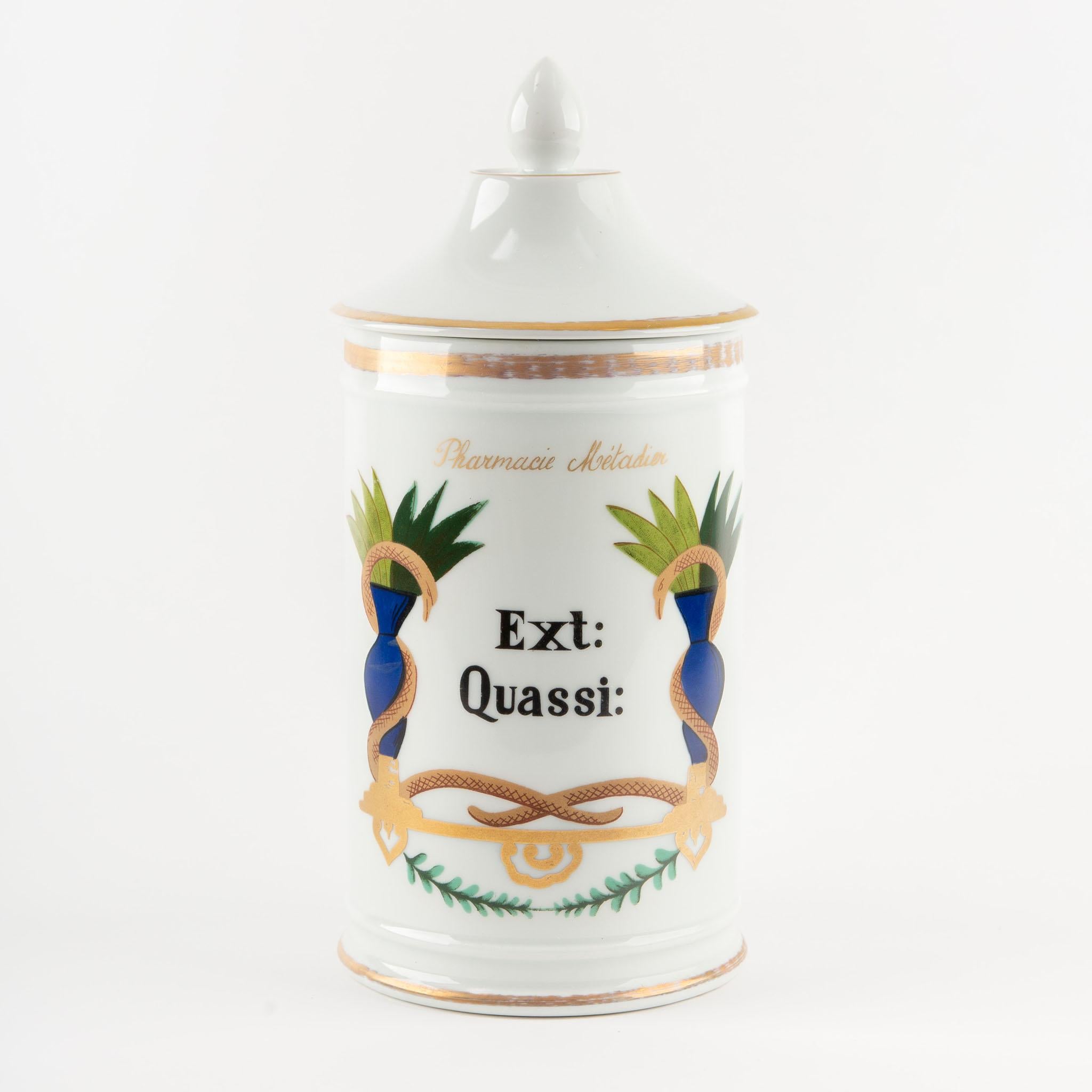 Set of six 19th century French pharmacy apothecary jars, each crafted in fine white porcelain with domed lids topped by gilt finials and decorated with neoclassical caduceus and laurel motifs in vivid blue, green, and gold. The jars are labeled in