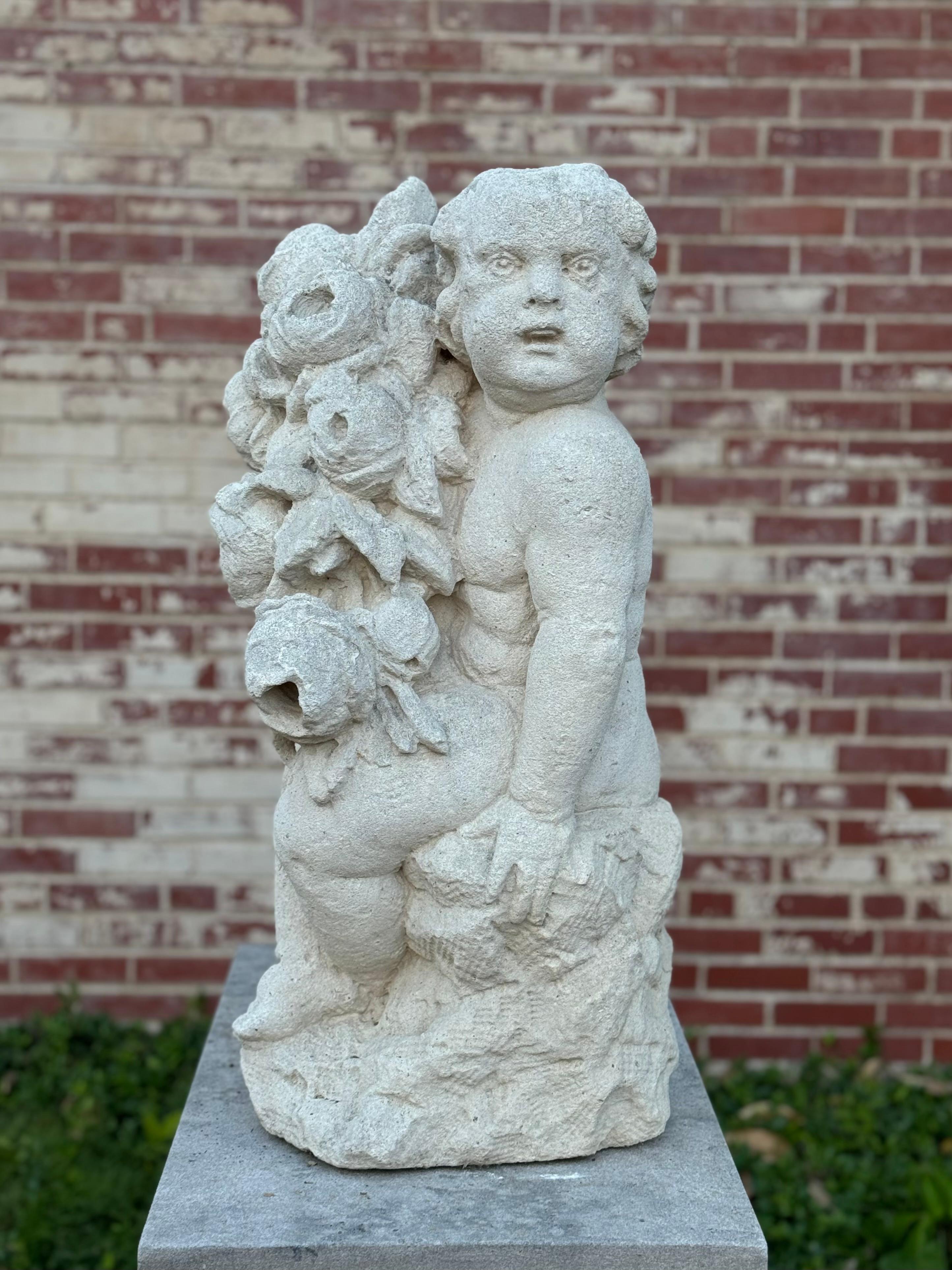 Antique French 19th century or possibly earlier, large hand-carved limestone cherub or putti garden statue or sculpture from a very prominent and historic St. Louis estate on the grounds of St. Louis Country Club. Carved from a single block of