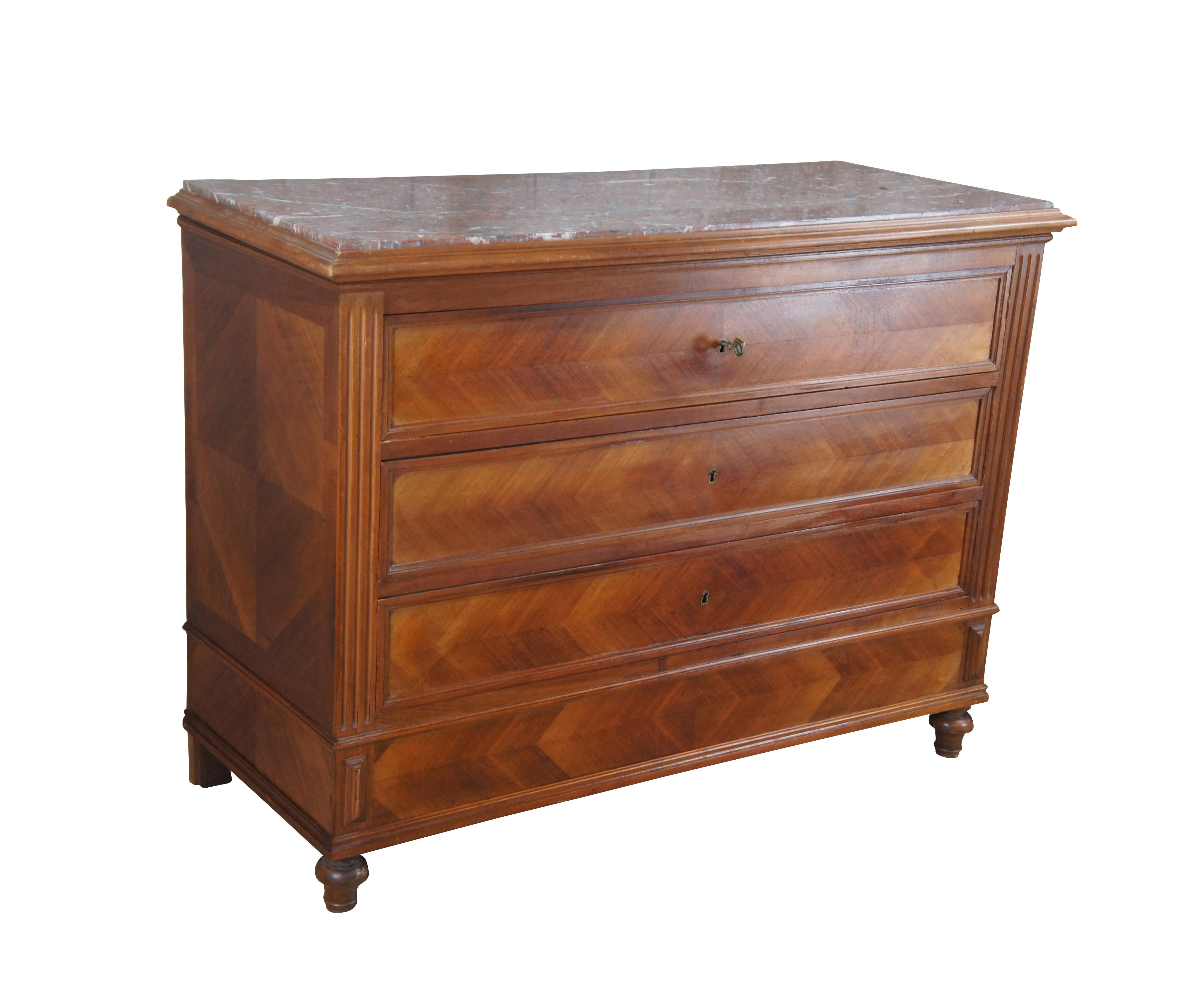 An exceptional 19th Century Louis Philippe Commode. Made from walnut with three hand dovetailed oak drawers. Features a recessed drawer configuration with fluted stiles, inset royal rouge marble top and bun feet. The chest has matchbook walnut front