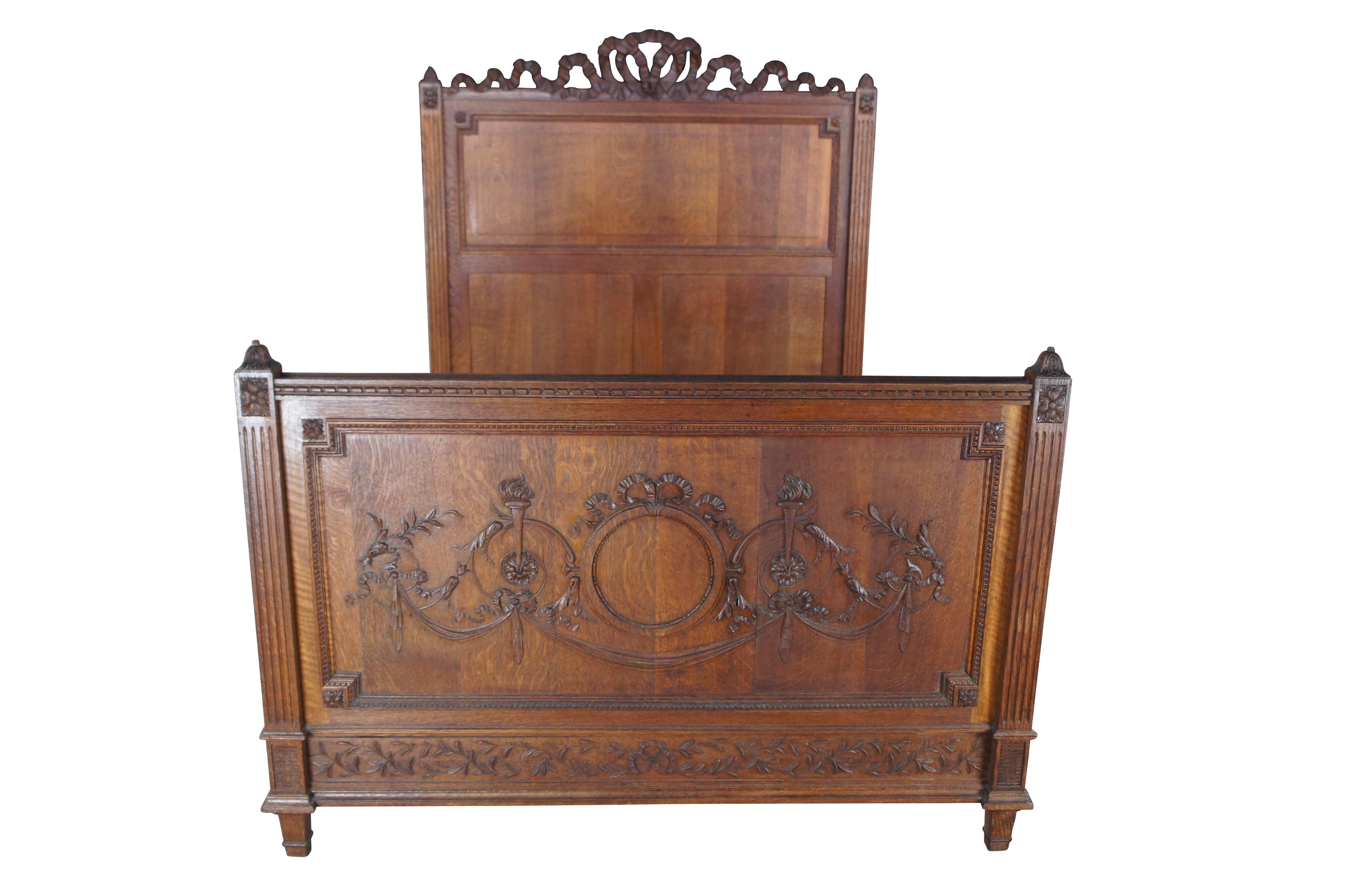Exquisite antique 19th century French Louis XVI Full Size Bed. Made from solid quartersawn oak with meticulous carving throughout.  Features square fluted posts with French medallions.  The footboard is beautifully carved with a neoclassical scene