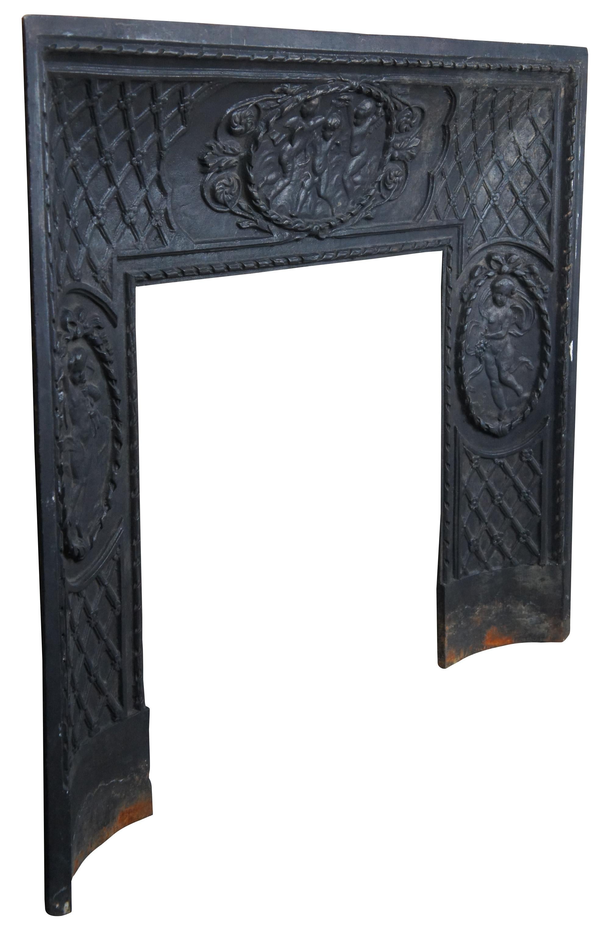 A rare and impressive mid 19th century French cast iron fireplace insert or surround. A concave form with meticulous detail. Features three cherubs scenes, each set within a neoclassical oval ribboned frame. The beautiful scenes are offset by a
