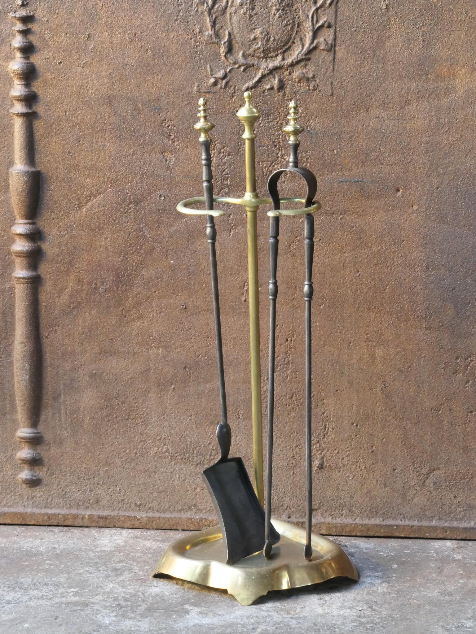 19th Century French Napoleon III fireplace tool set. The tool set consists of tongs, shovel and stand. The stand is made of brass and the tools are made from iron with brass decorations. The set is in a good condition and fully functional.