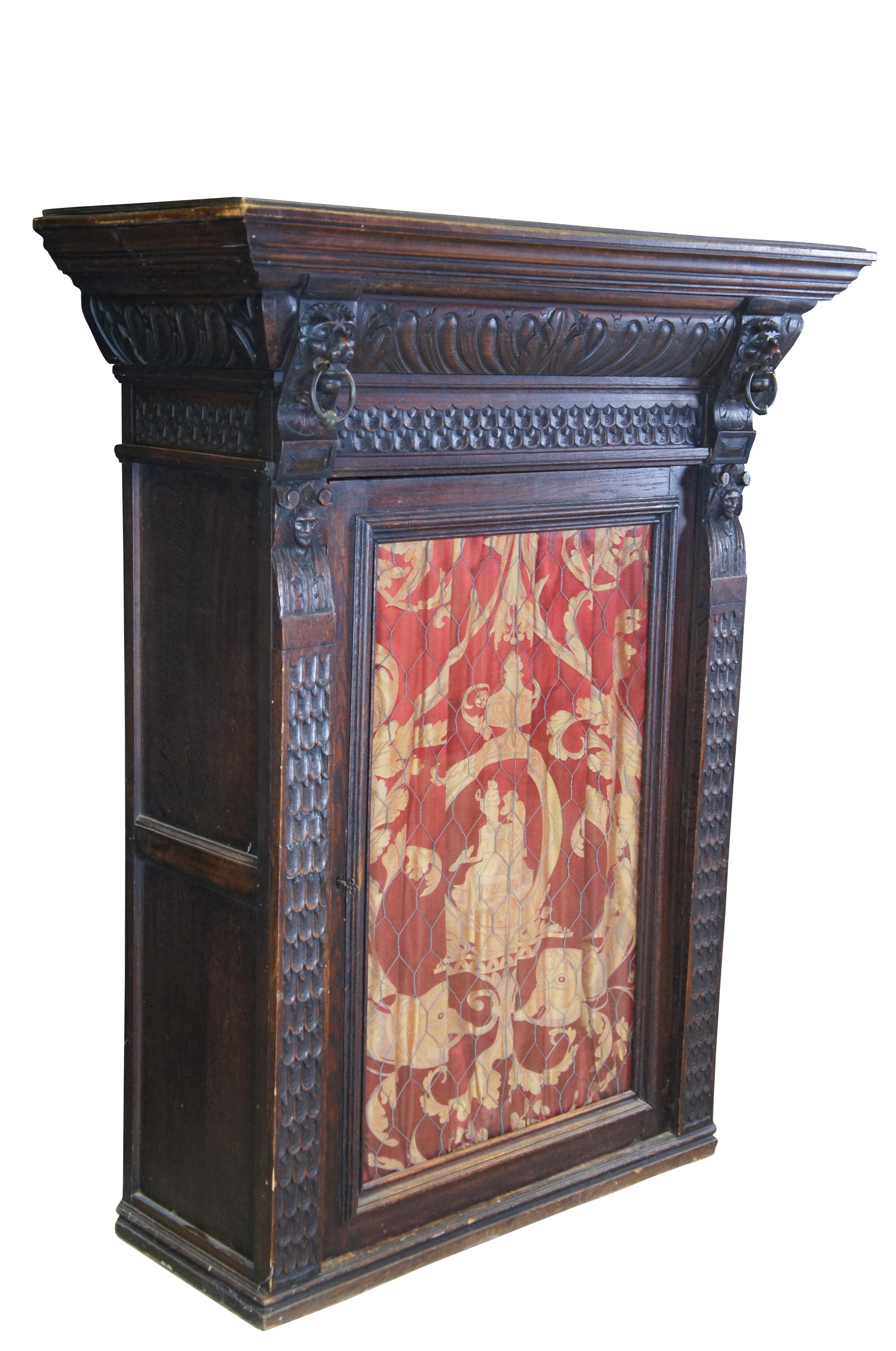 Beautiful late 19th century French Renaissance Revival hanging cabinet.  Great for use as a bookcase, curio, vitrine or display cabinet.  Made from oak with intricate carved details.  Features ornate gadrooning along the crown flanked by carved lion