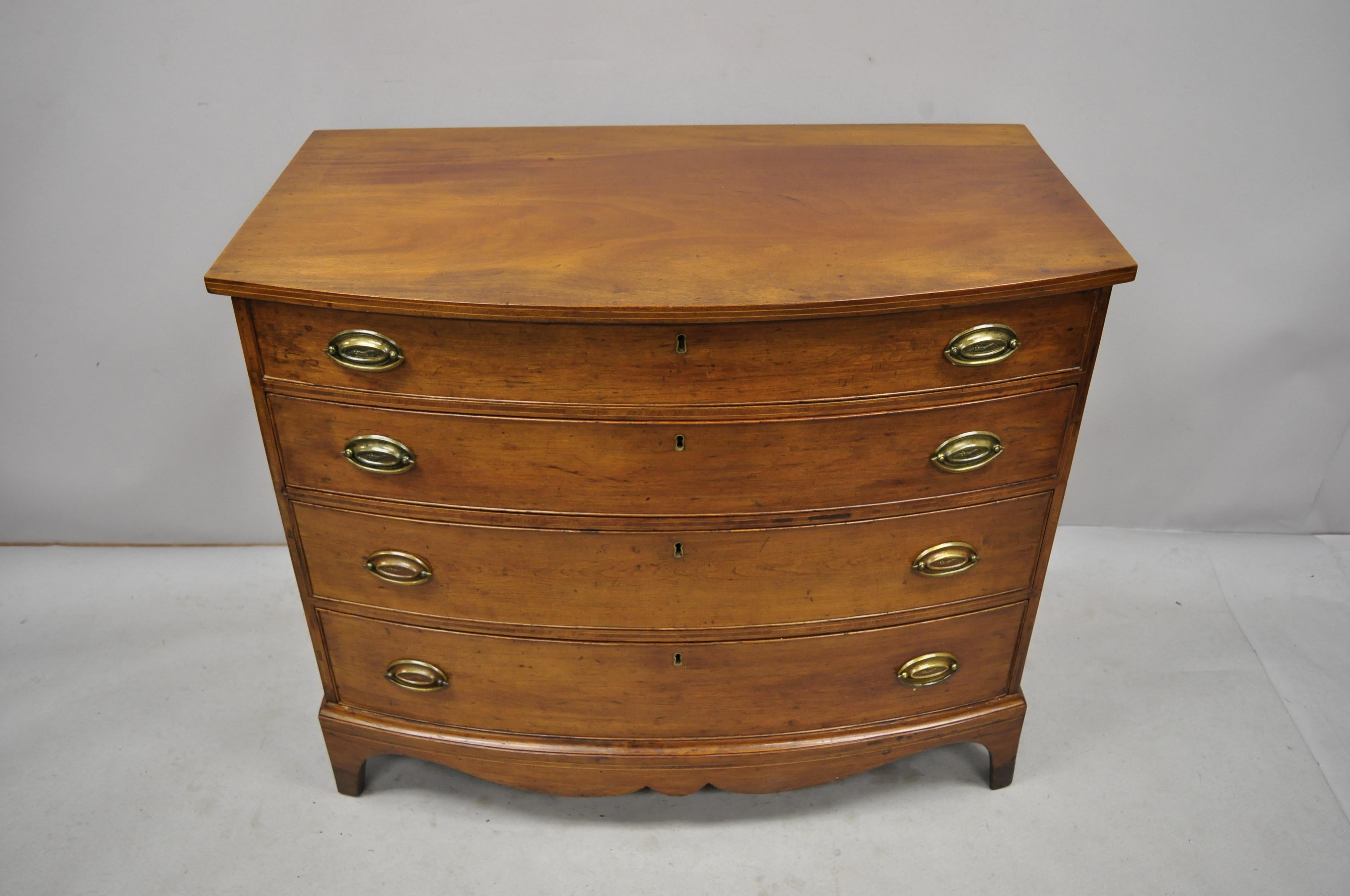 Antique 19th century Hepplewhite bow front mahogany English chest of drawers dresser. Listing includes a serpentine carved skirt, bow front, satinwood pencil inlay, remarkable patina, beautiful wood grain, no key, but unlocked, 4 dovetailed drawers,