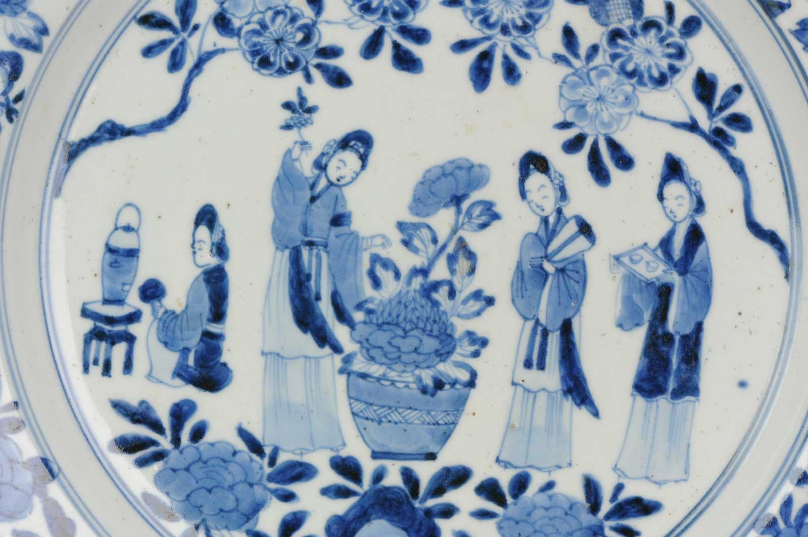 Description:
A very nicely decorated Japanese Porcelain dish in Chinese style. Marked at base.

The central scene is of a busy garden, two elegant ladies are next to a large jardinière of flowering peony. One of the ladies is holding a fan. she