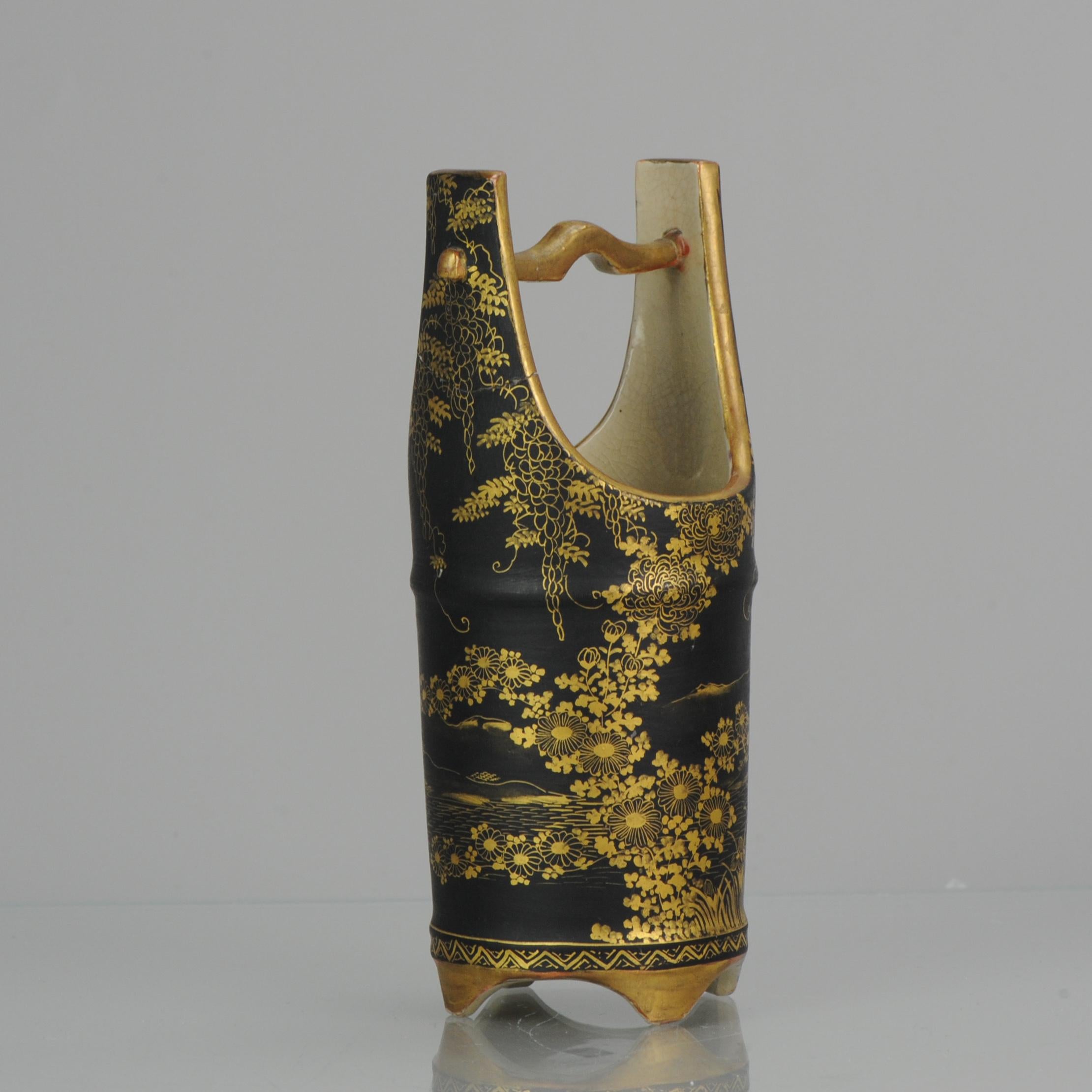 This is a rare and unusual Japanese Satsuma Basket vase from the Meiji Period (1868-1911). It is superbly decorated with a finely detailed Japanese landscape in gold on black background with also Grape vines. The vase is signed on the base.