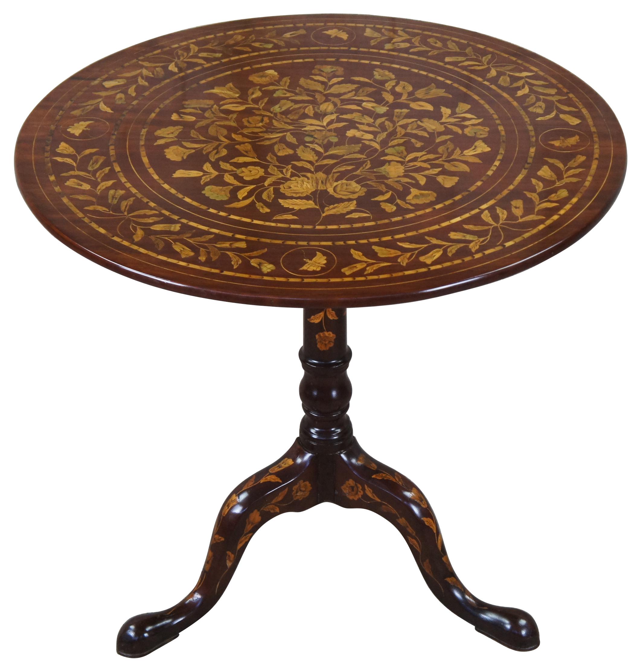 A very fine example of a mid Victorian dutch marquetry tilt top table. Made from Mahogany with beautiful floral and rose inlays. Features butterflies along each quadrant. The table is supported by a turned baluster support terminating into a tripod