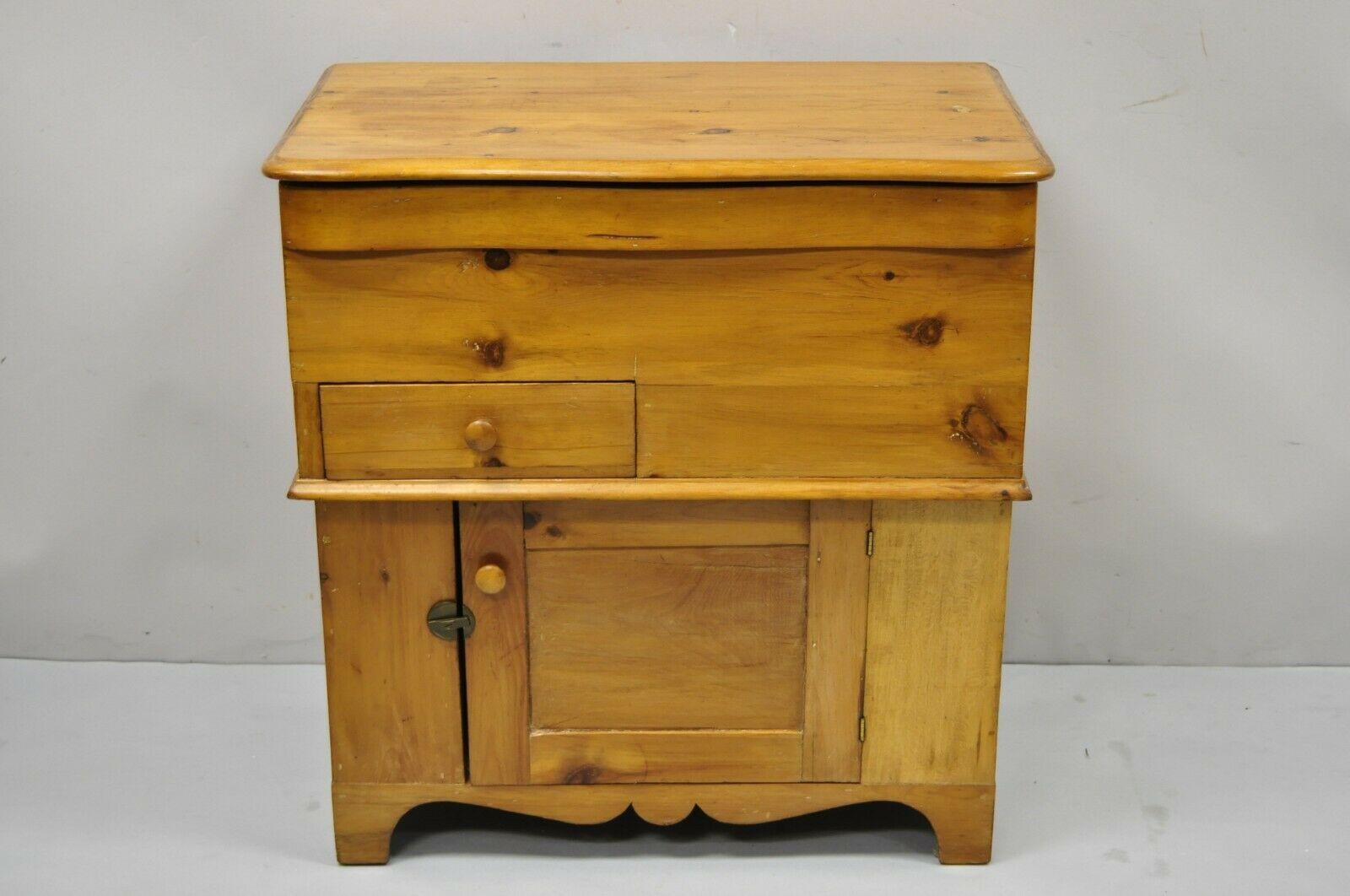 Antique 19th C. Primitive Pine wood lift top dry sink washstand commode cabinet. Item features serpentine lift top lid, solid pine wood frame, beautiful wood grain, distressed finish, 1 swing door, 1 dovetailed drawer, very nice antique item,