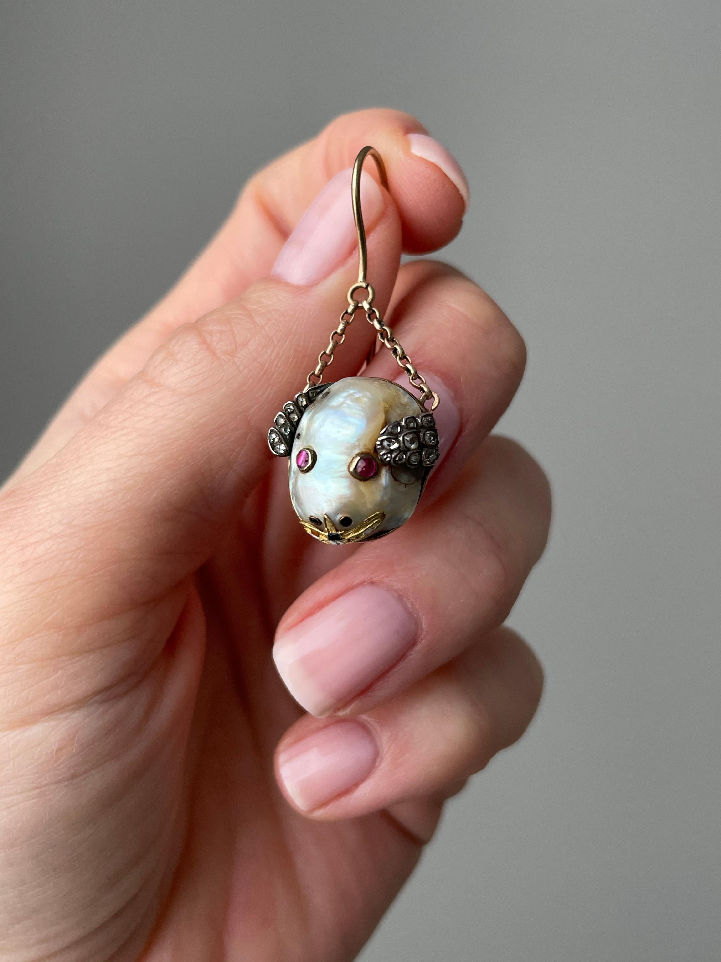 A pair of whimsical baroque pearl mice with glowing ruby eyes, twinkling diamond ears and an enameled grin. Dating to around 1850, these crazy critters are suspended by two short lengths of delicate, hand fabricated chain, giving them lots of