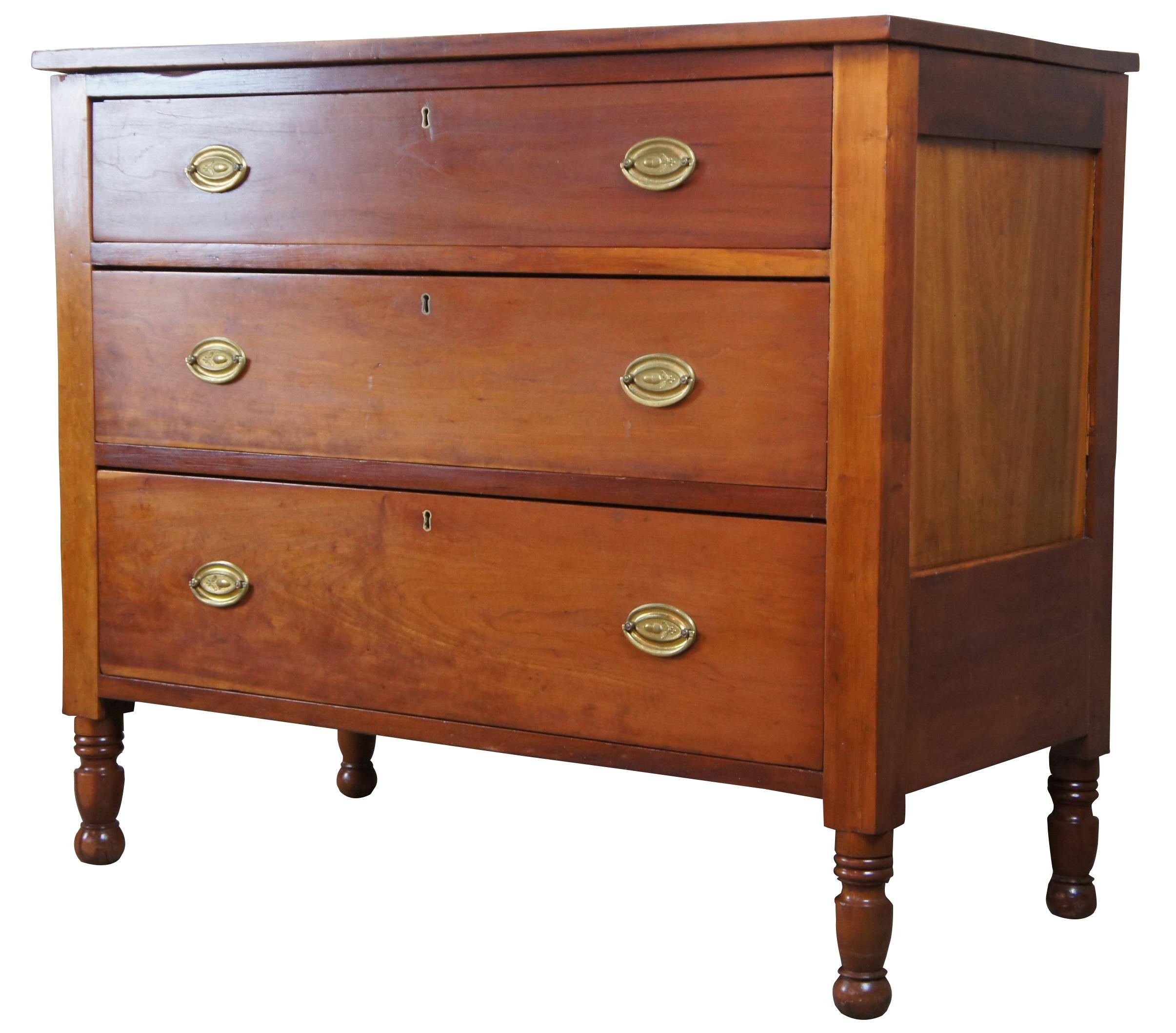 Antique Sheraton chest of drawers. Made from cherry with a rectangular form. Features three hand dovetailed drawers and turned nub feet.
 