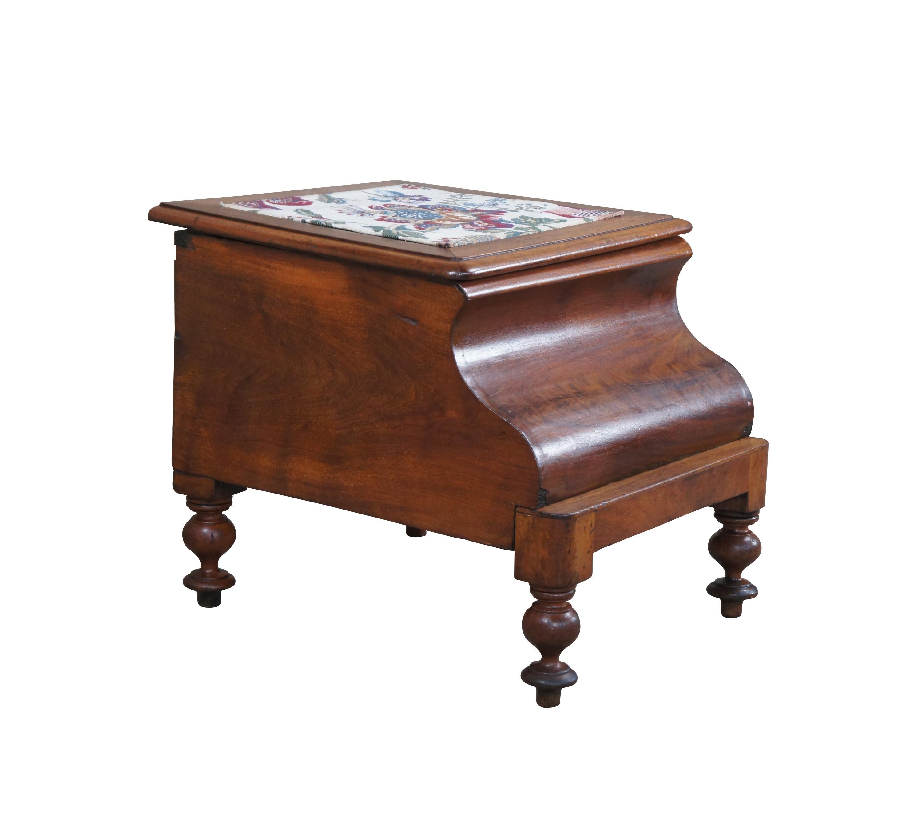 Mid 19th century chamber pot or commode. Made from mahogany with a crotch mahogany contoured front. Features a pull out needelepoint steep stool and matching embroidered top. The top opens to a porcelain chamber with lid. The case is supported by