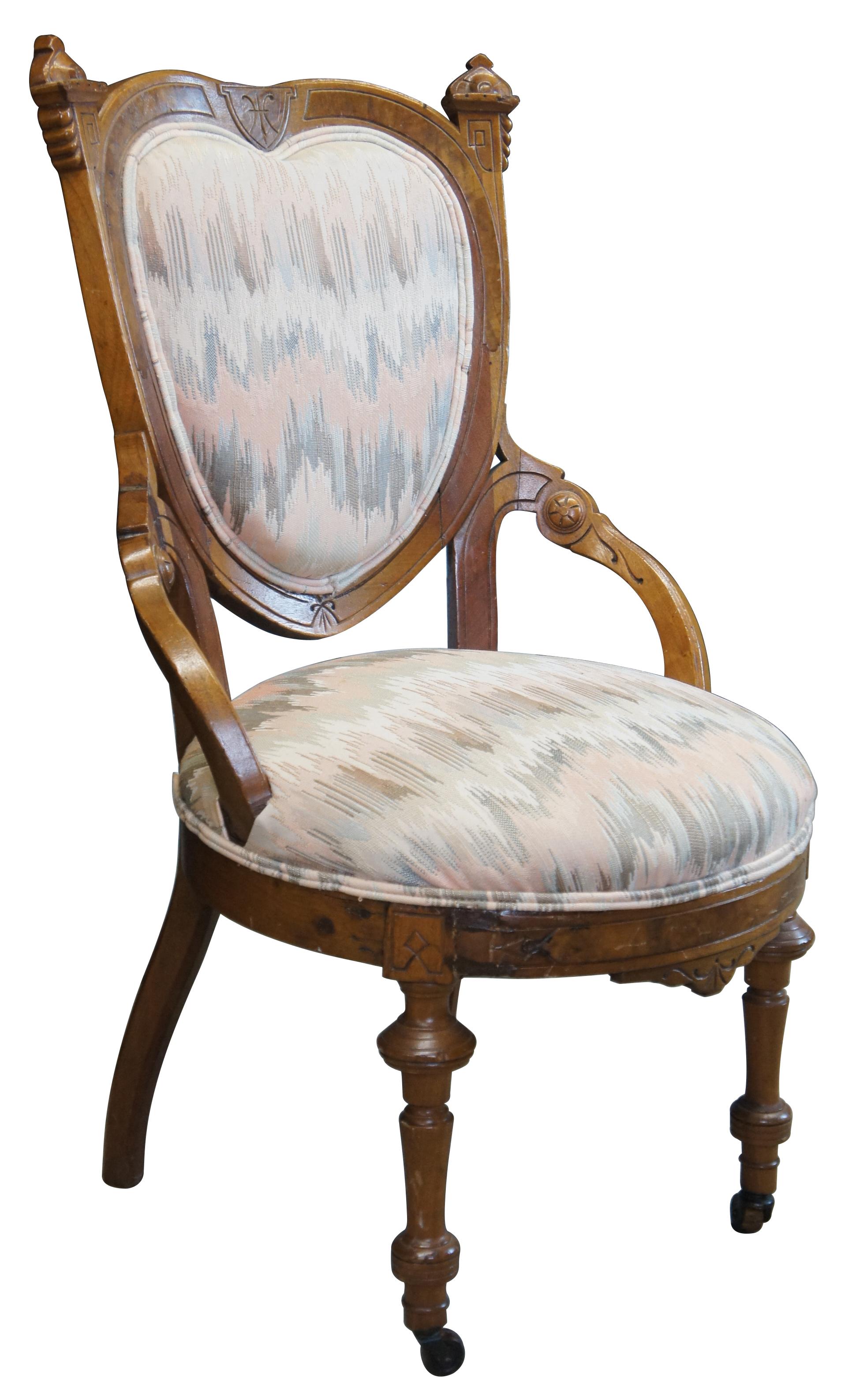 Antique 19th century Eastlake Victorian parlor chair. Made of walnut featuring ballooned heart shape back and turned and carved accents.
 