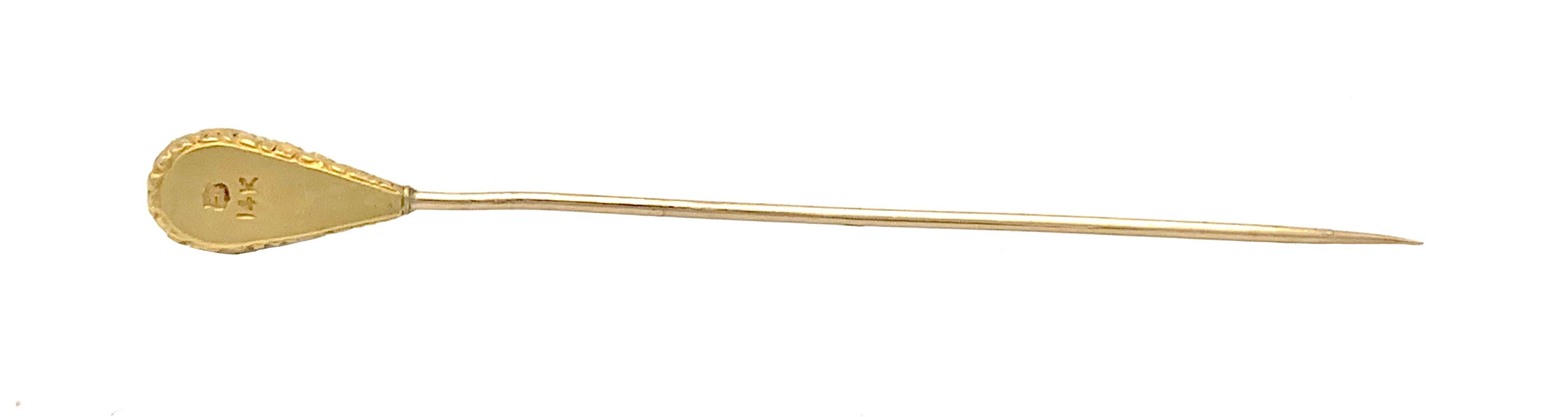 This elegant stickpin was made out of 14K yellow gold in the last quarter of the 19th century. The gold is embossed in high relief and shows a foliage design. The center of the pin head is decorated with a small natural pearl. On the reverse the