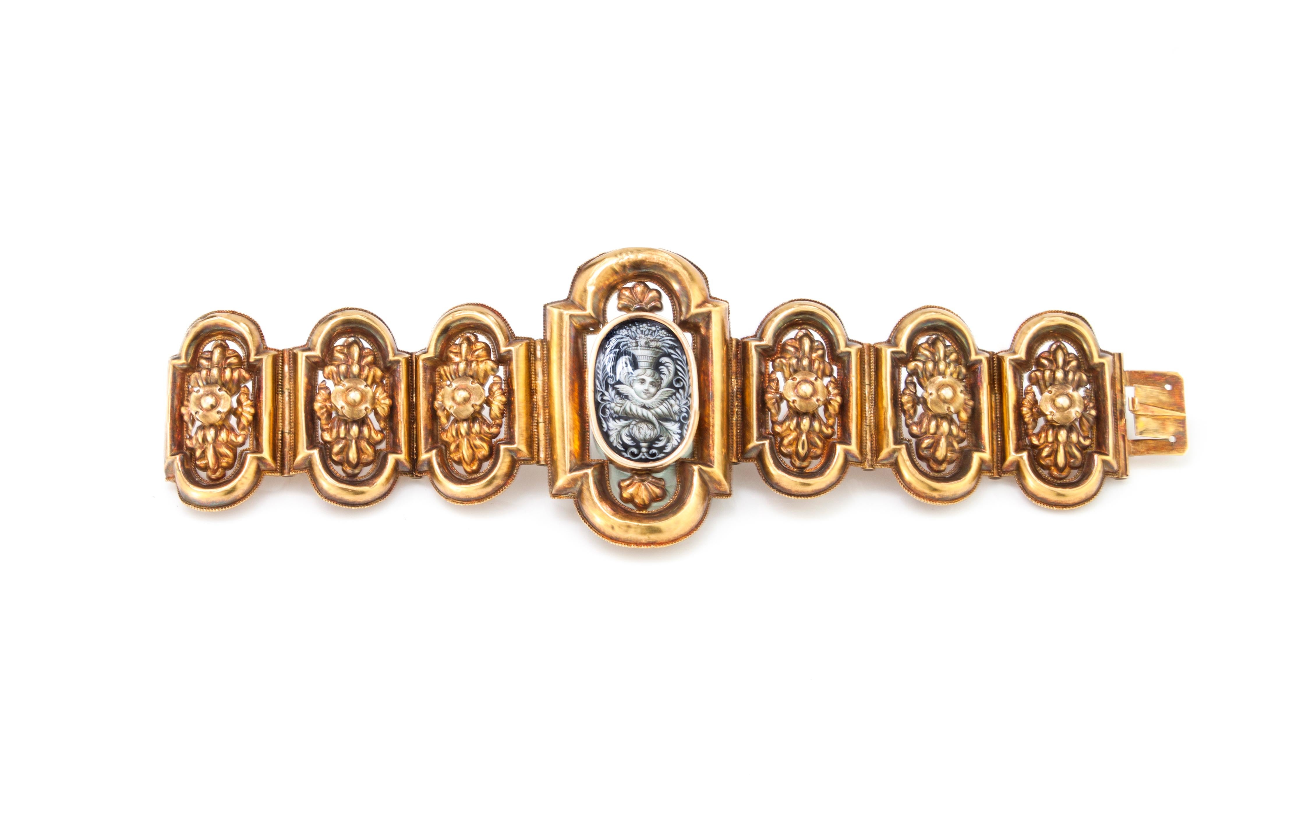 Antique 18kt yellow gold ladies bracelet, with enamel center depicting a putto.
Handmade in Italy, Circa 1870's
Tested positive for 18kt gold.

Dimensions -
Weight : 28 grams
Length x Width: 17 x 5.2 cm

Condition: Bracelet is has some age related