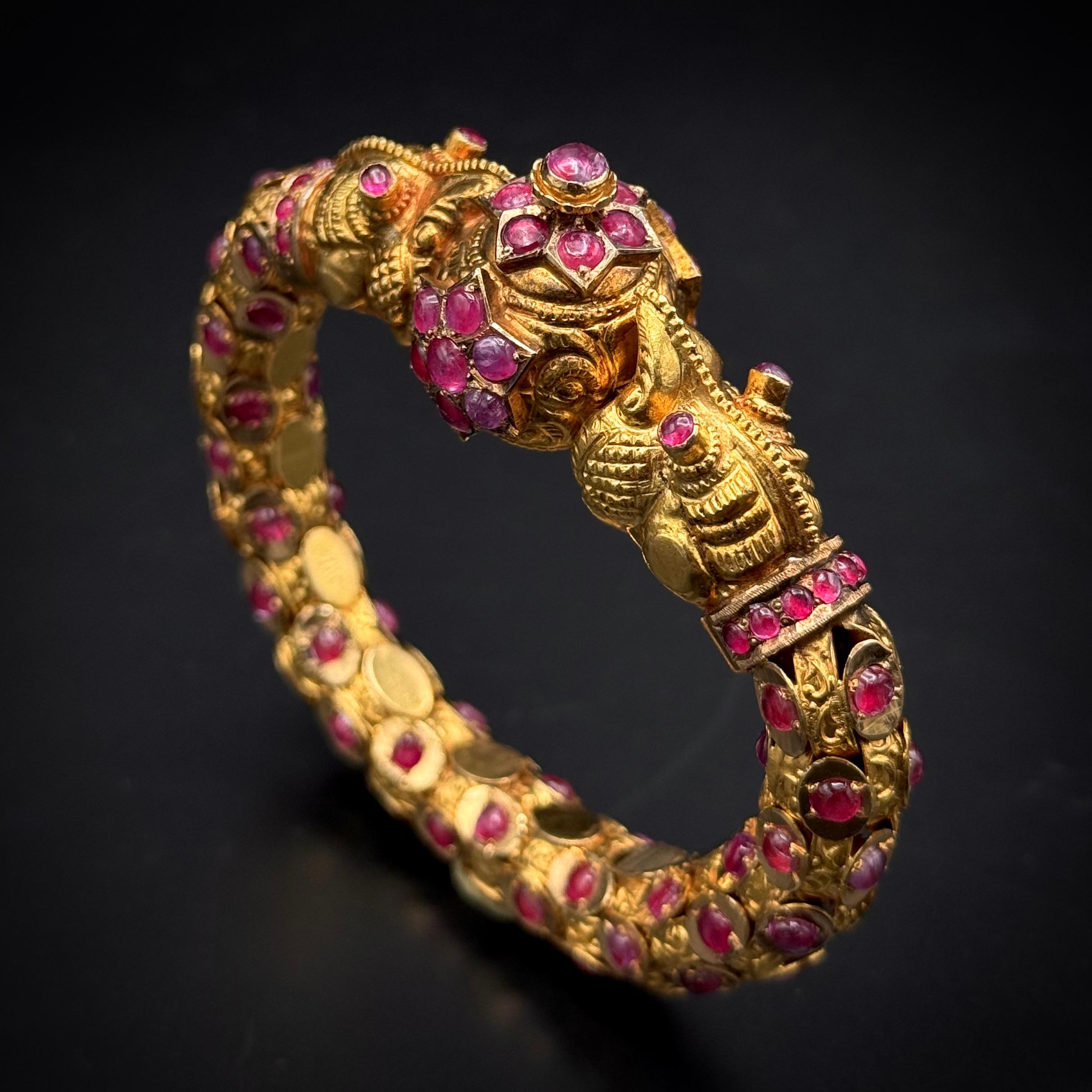 This exquisite late Victorian chimera ruby bracelet, crafted in rose gold, exudes the mystique and exoticism of the East with its distinctly Indian-inspired design. Dating to the late 19th century, it is a striking testament to the Western