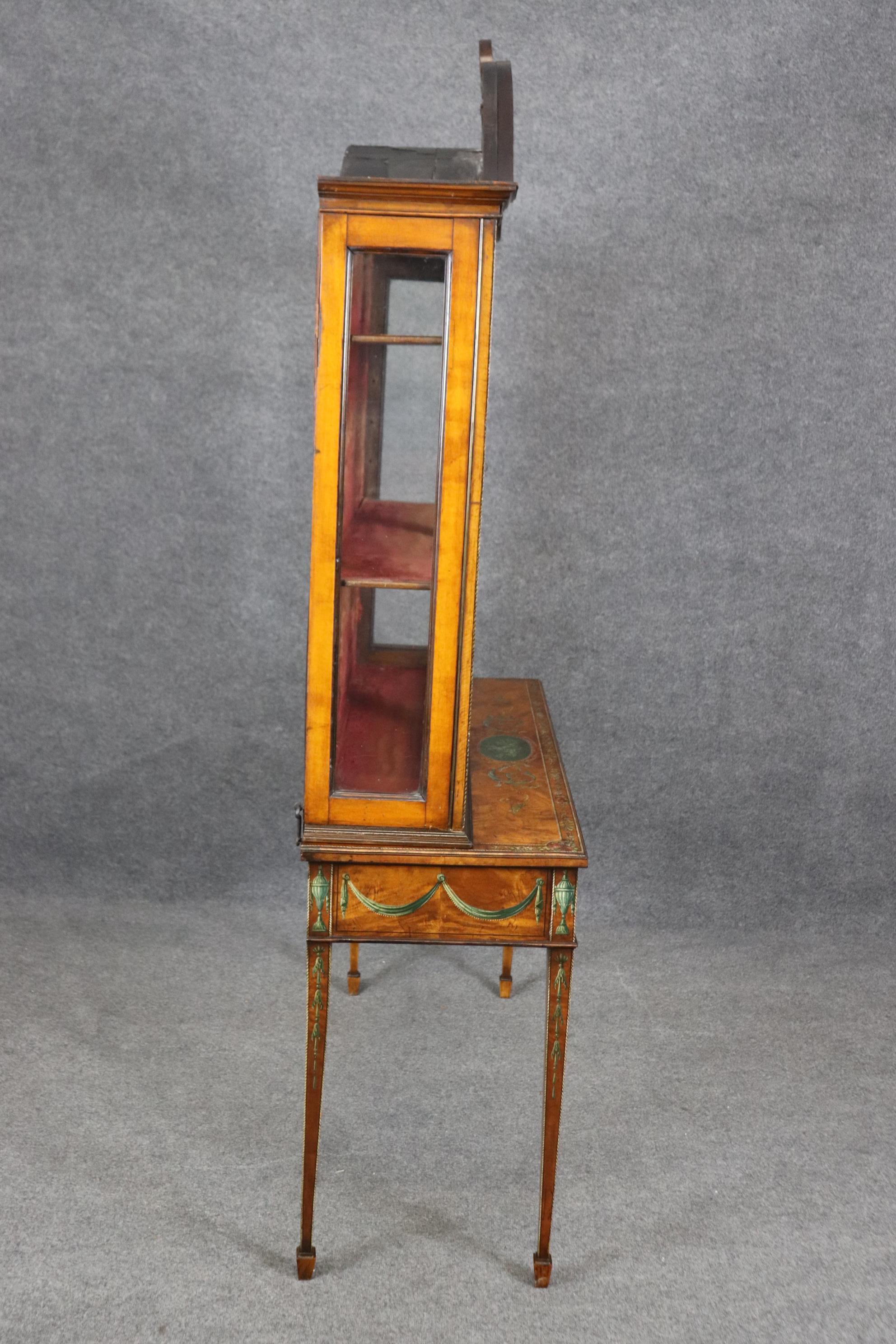 Dimensions: Height: 82 in Width: 48in Depth: 17 1/2 in 

This antique 19th century English Adams style curio cabinet vitrine is made of the highest quality! If you look at the photos provided, you will see the beautiful ornate paint decoration