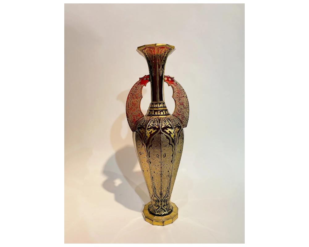 Antique 19th century Alhambra Bohemian ruby red glass vase

in Great condition some minor fading to the gilding throughout consistant with age and use. 
there is some small chips to one of the handles at the bottom please see the photos 
the