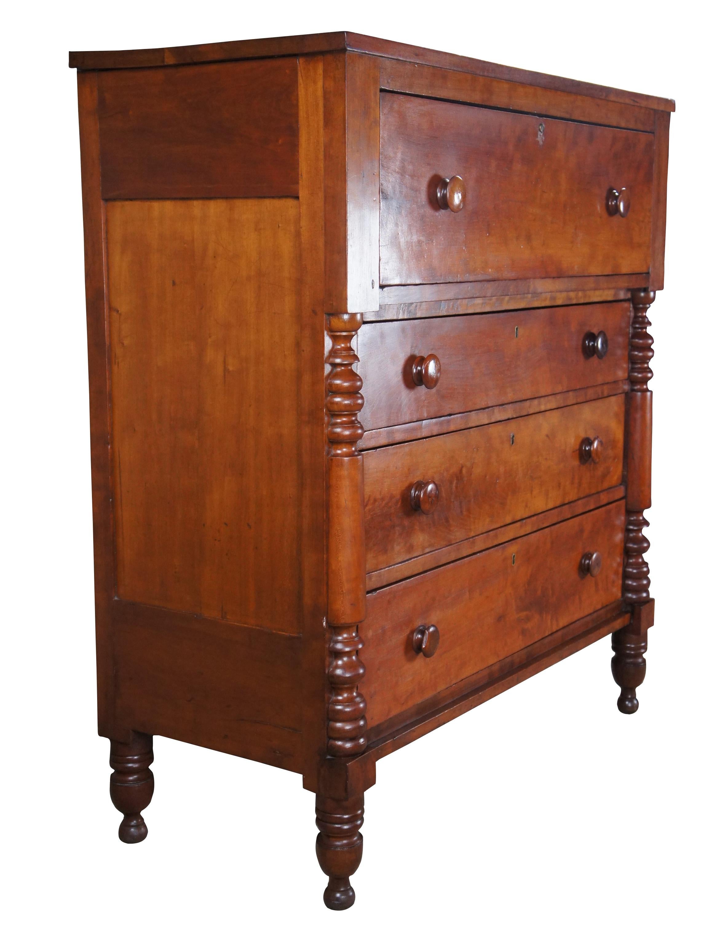 Antique 19th century American Empire tallboy chest or dresser featuring four drawers and quarter turned and ribbed post accents. The chest is supported by turned turnip feet. Measure: 47