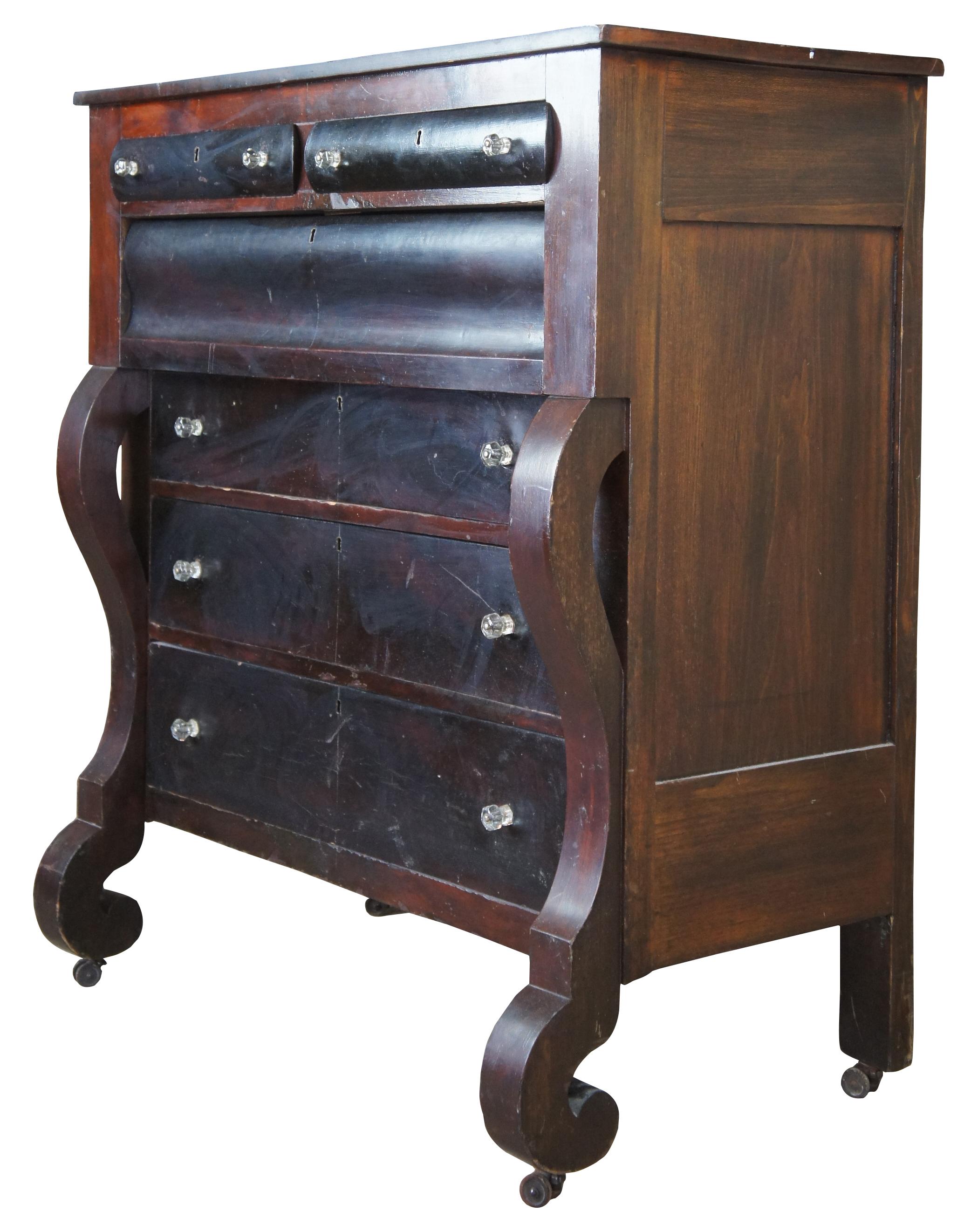 Mid 19th century American Empire tall boy chest. Features a rectangular form with scrolled front. Made from walnut with 6 drawers, glass knobs and double casters. 

Surface dimensions - 21