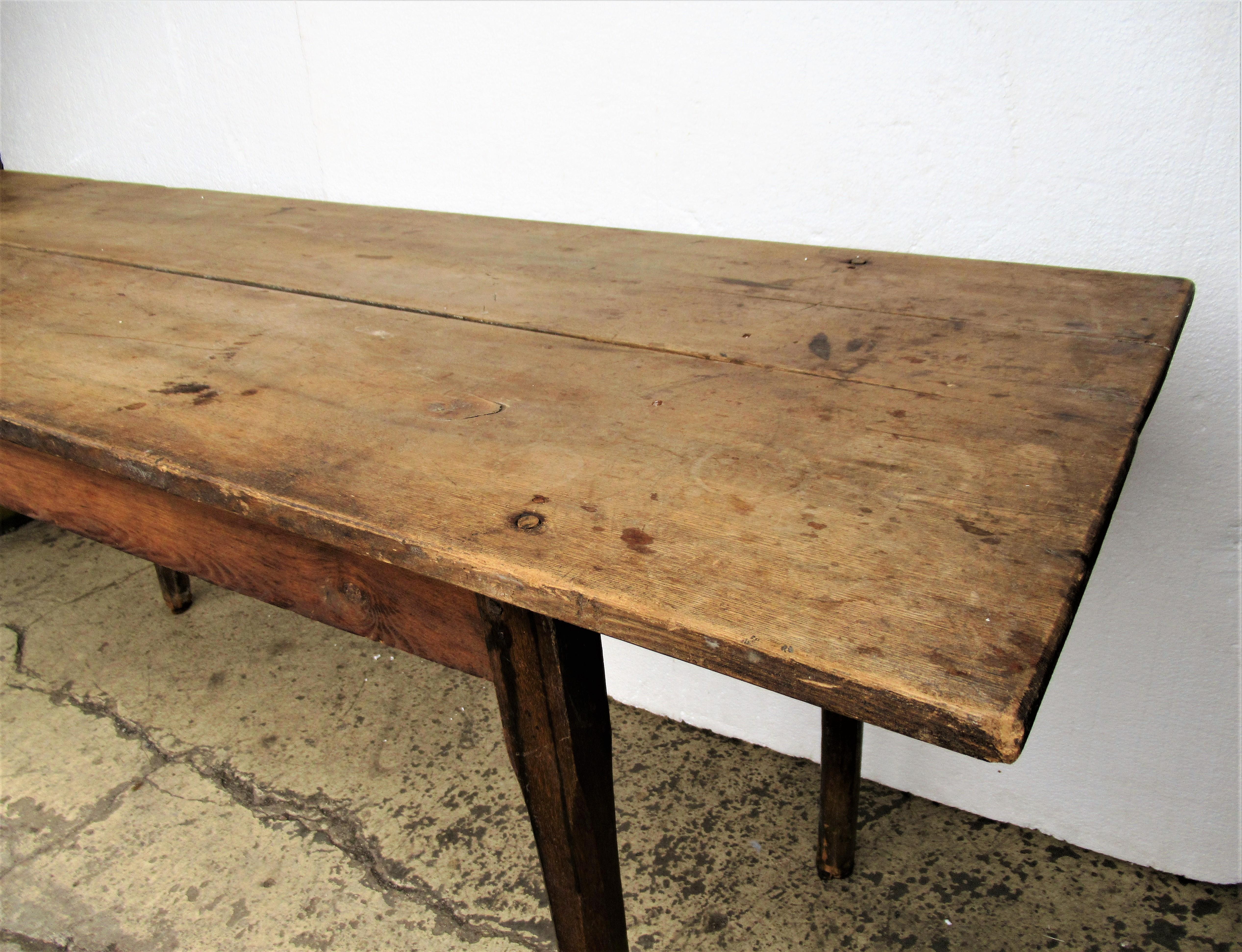 Antique 19th century American farm work table with a long over hanging two board pale chestnut top. Early pegged construction and nicely tapered chamfered legs. Beautifully aged original old surface color and great form.
 Found in Central New York