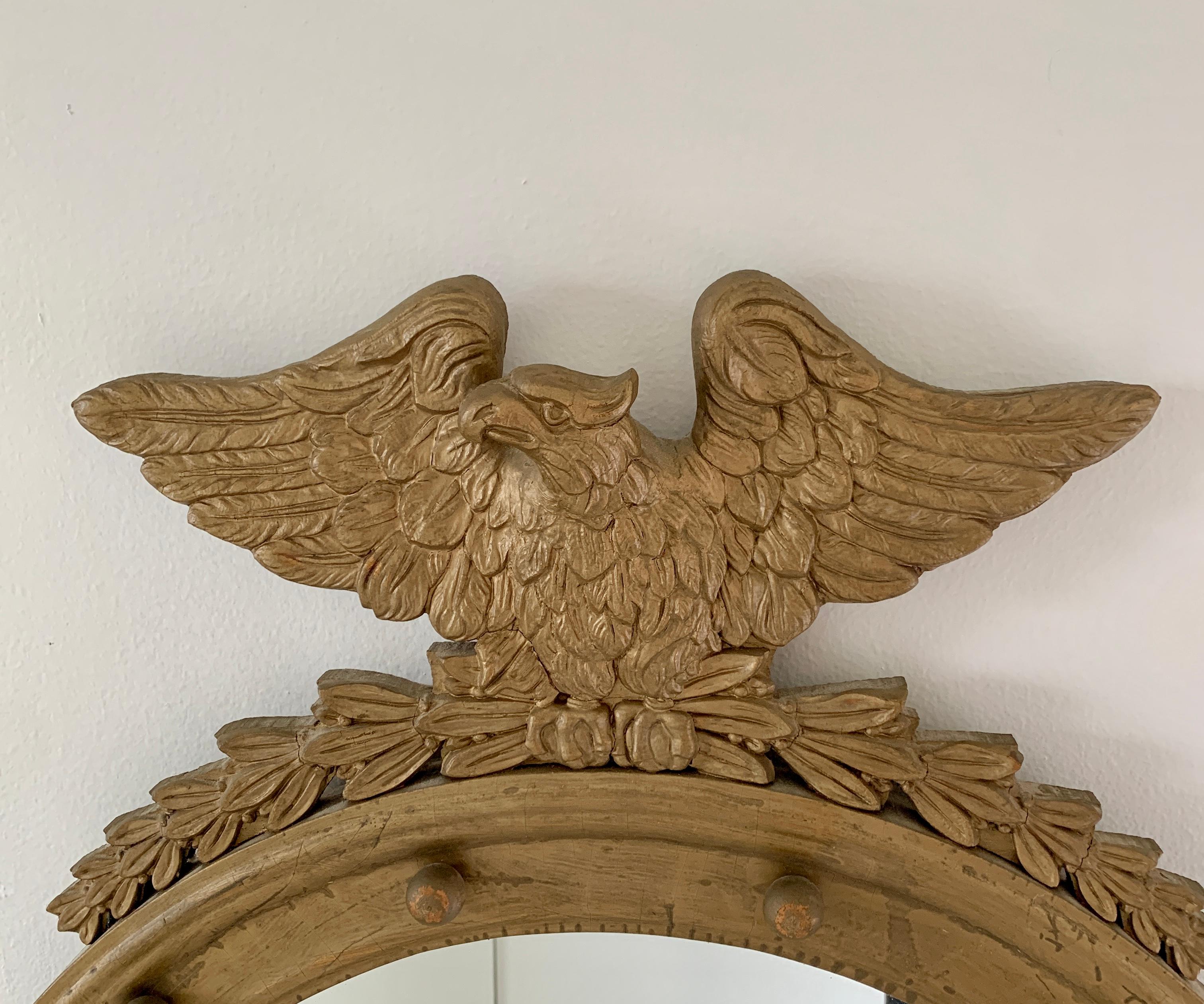A gorgeous Federal or Regency style wall mirror featuring a carved eagle with open wings standing on olive branches and 13 small spheres representing the original 13 colonies around the inside perimeter.

USA, late 19th century

giltwood frame,