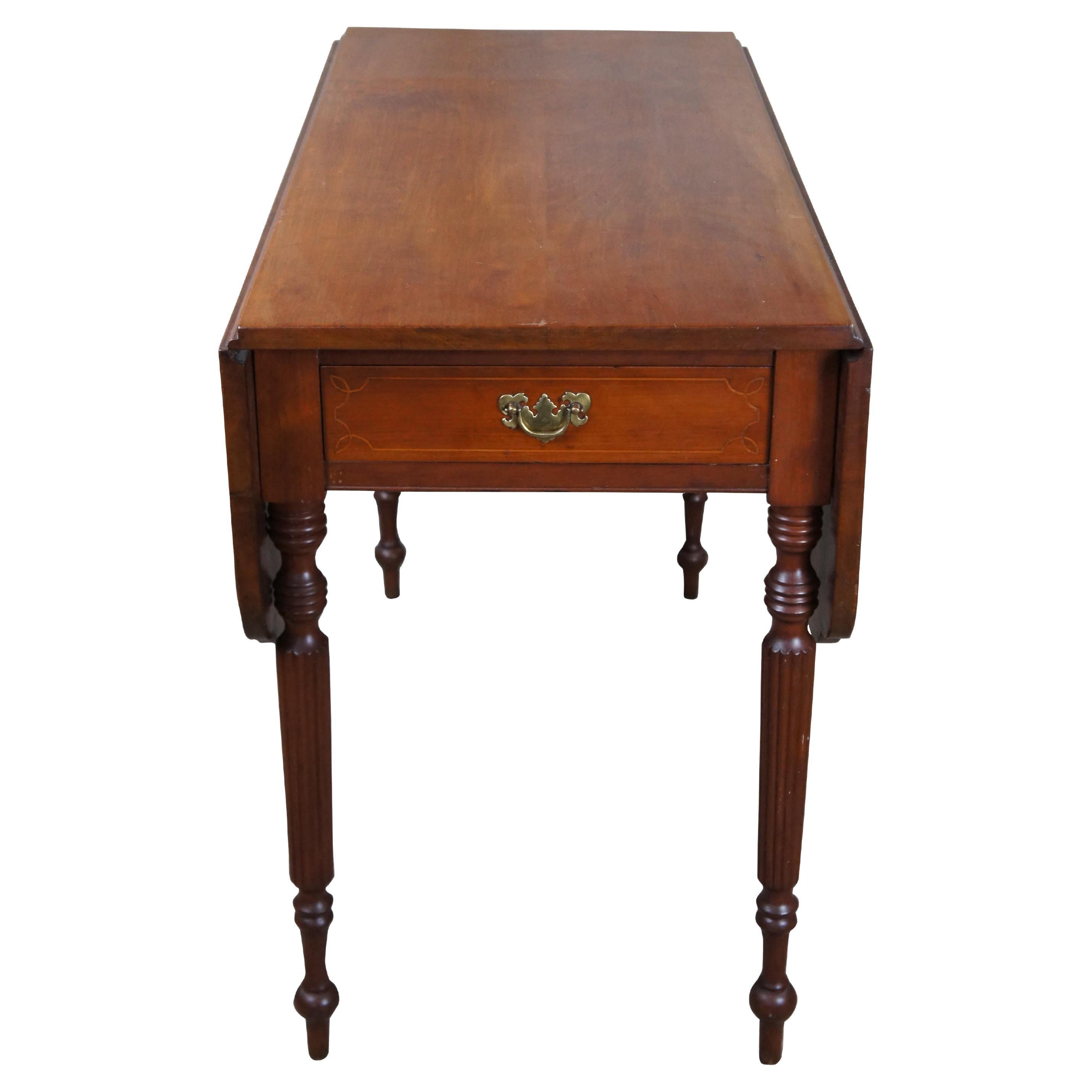 Early 19th Century American Sheraton Drop Leaf Table.  Made from cherry with a hand dovetailed and inlaid drawer within the frieze.  The table features contoured corners and is supported by ring turned reeded legs leading to arrow feet.  Great for